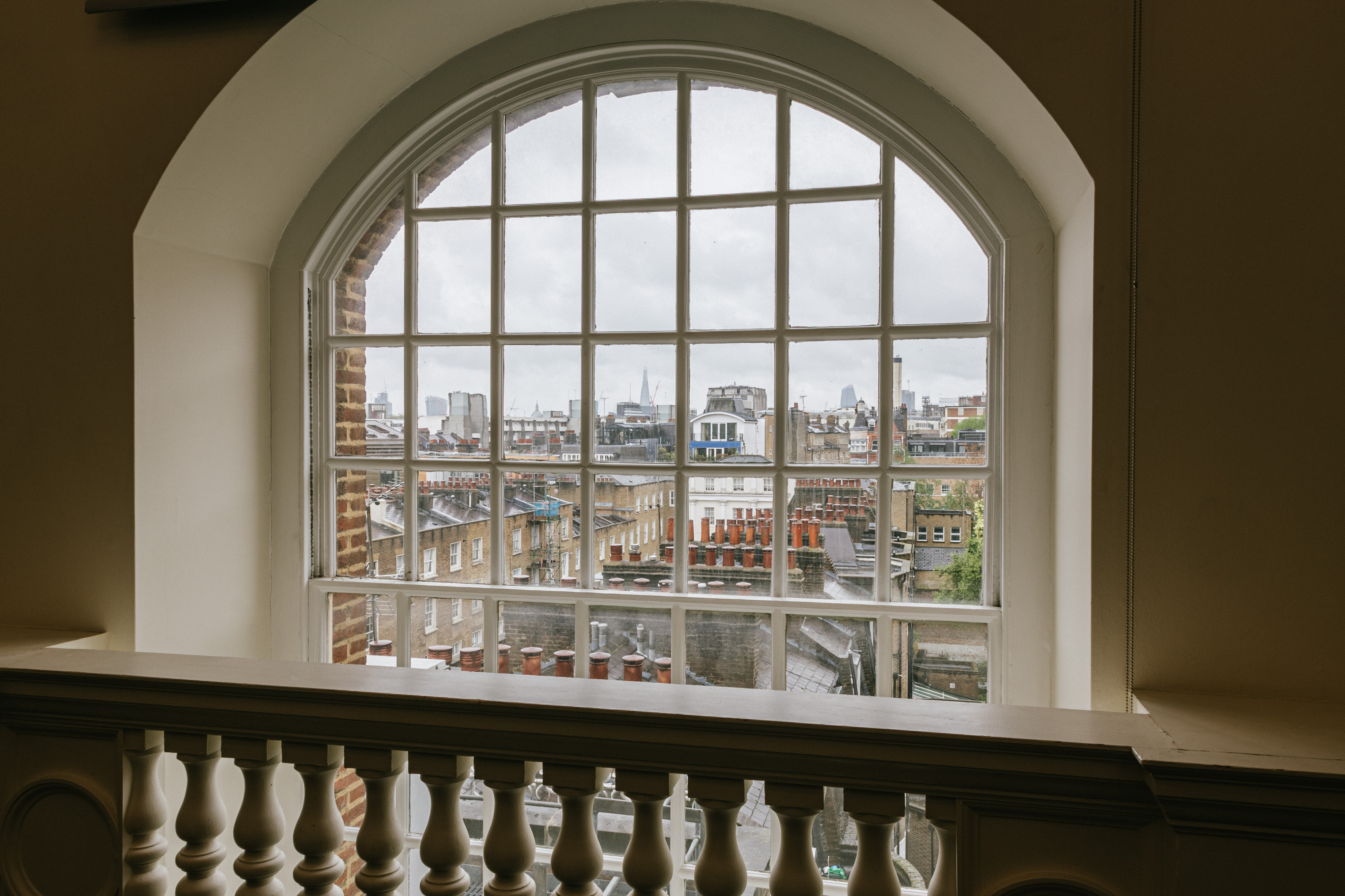 Harvey room in BMA House with arched window, perfect for networking events and creativity.