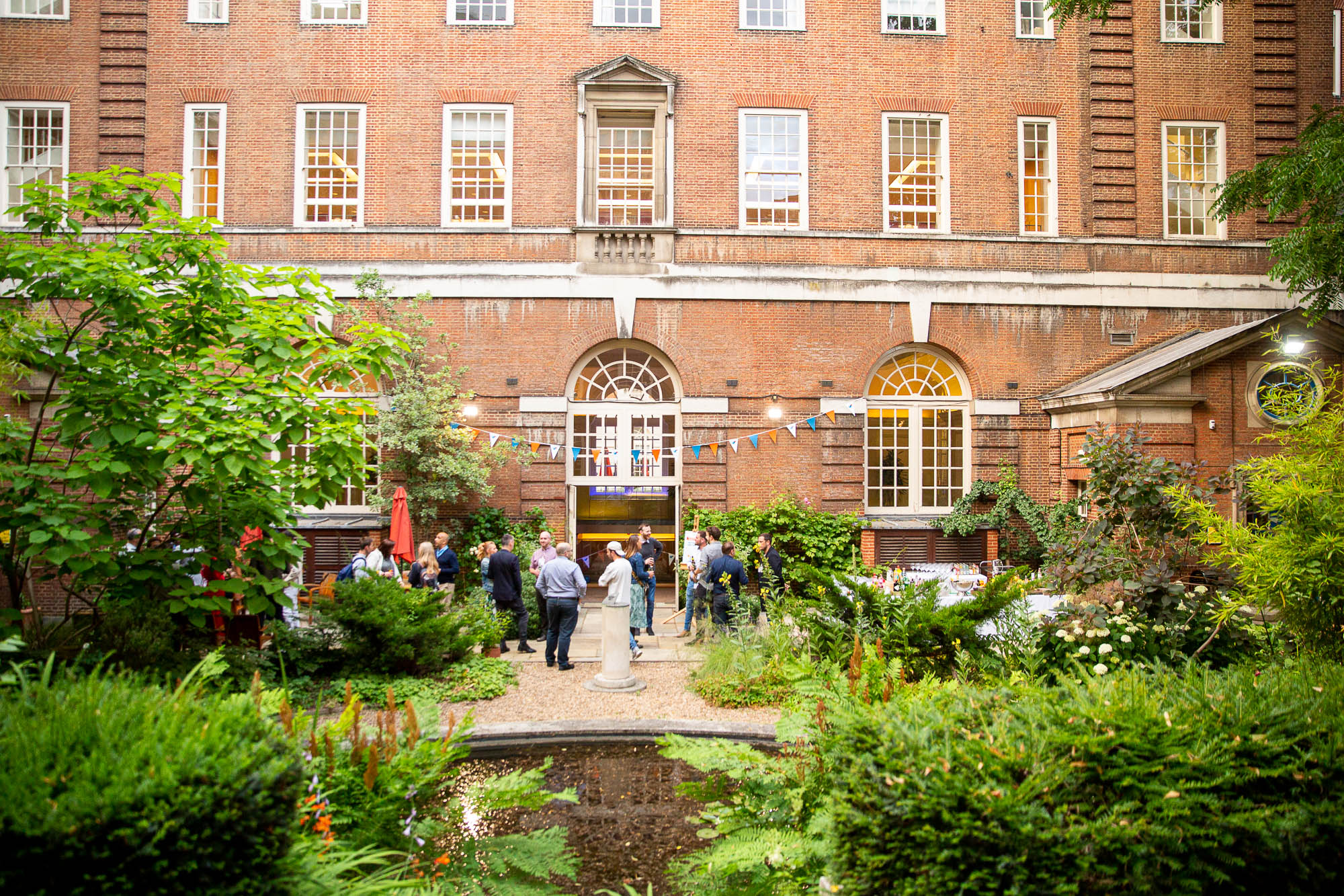 Charming outdoor venue with lush greenery for networking events at BMA House.