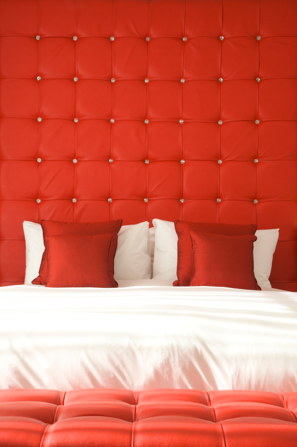 Ruby Loft Suite with red headboard, ideal for meetings and events in Bermondsey Square Hotel.