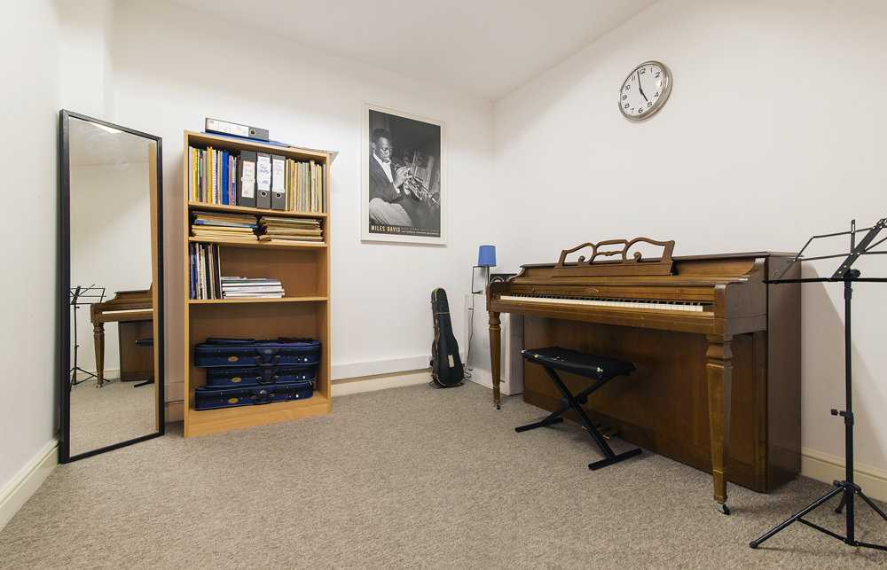 Cozy Small Music Room with piano for creative meetings and team-building activities.