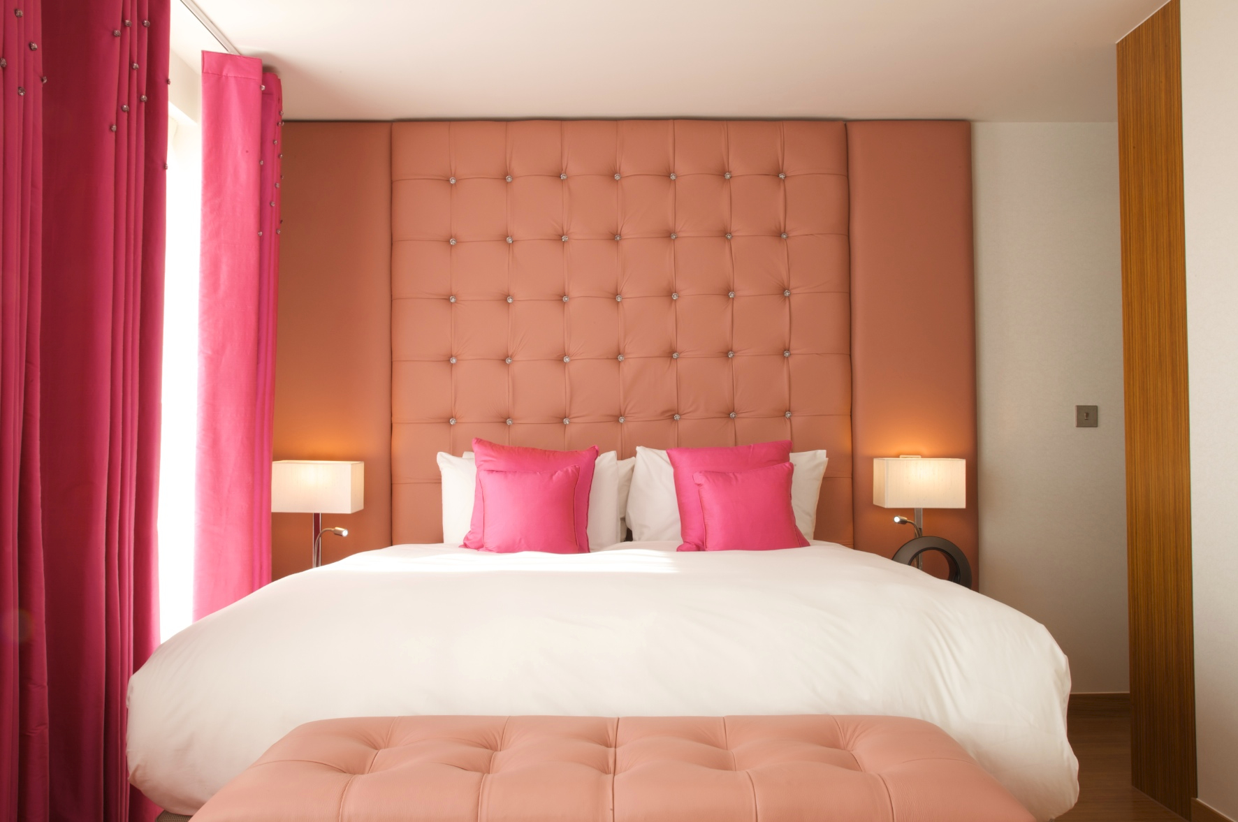 Jude Loft Suite at The Bermondsey Square Hotel with pink tufted headboard, perfect for retreats.