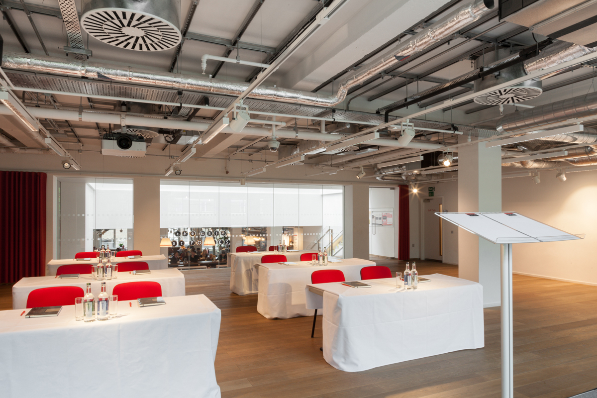 Whole Venue Auditorium with red chairs, ideal for workshops and presentations.