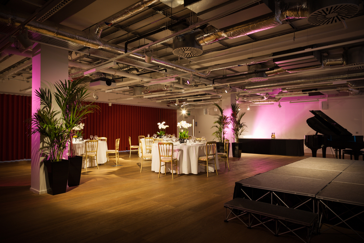 Elegant event space with round tables, ideal for corporate gatherings and celebrations.