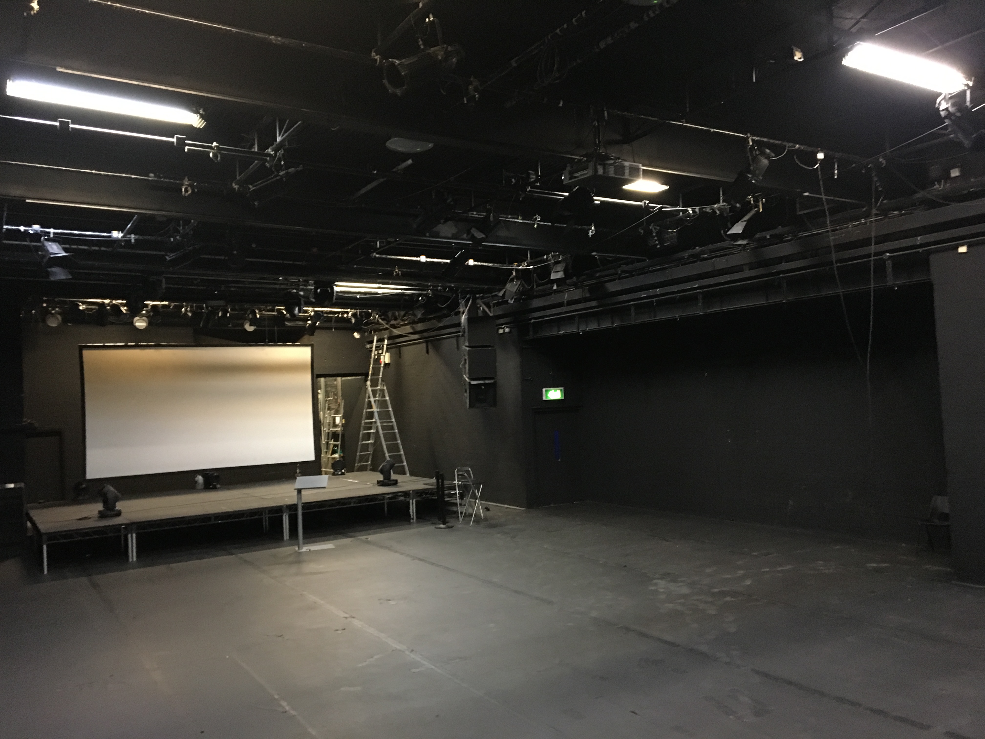 Versatile ICA Theatre with elevated stage, ideal for conferences and performances.
