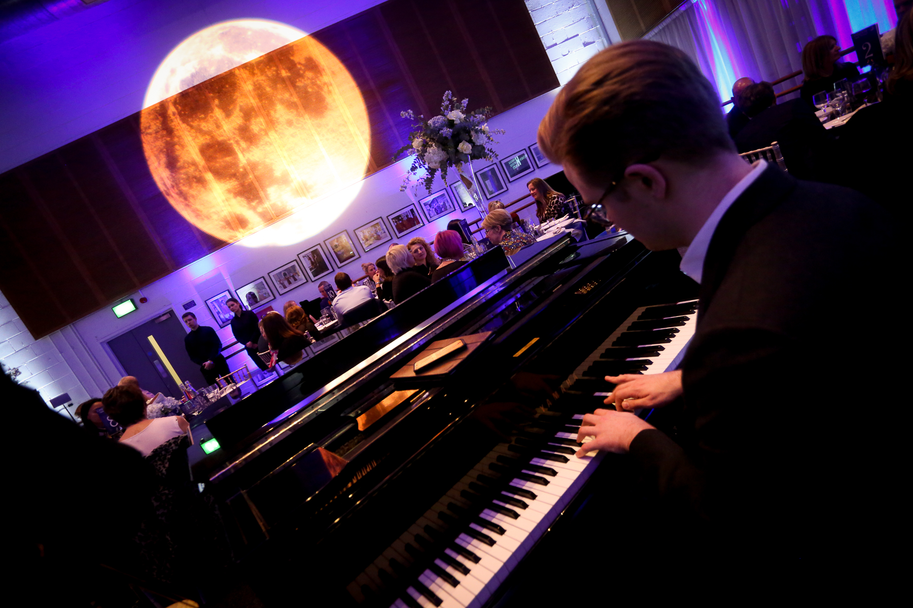 Event at Birmingham Hippodrome's Studio 5 with pianist, luxury decor, moon projection.