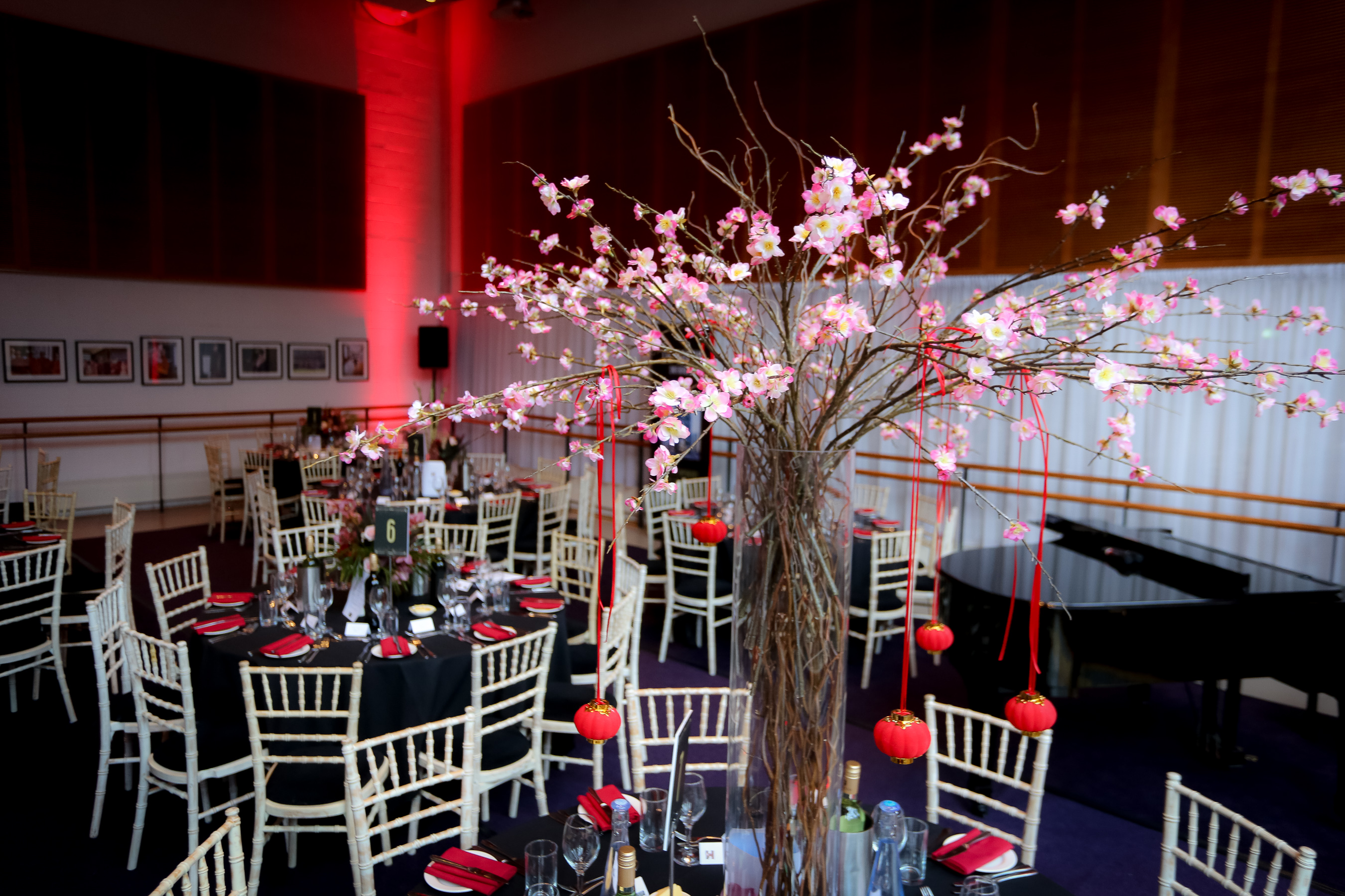 Elegant event space in Birmingham Hippodrome with cherry blossom centerpieces.