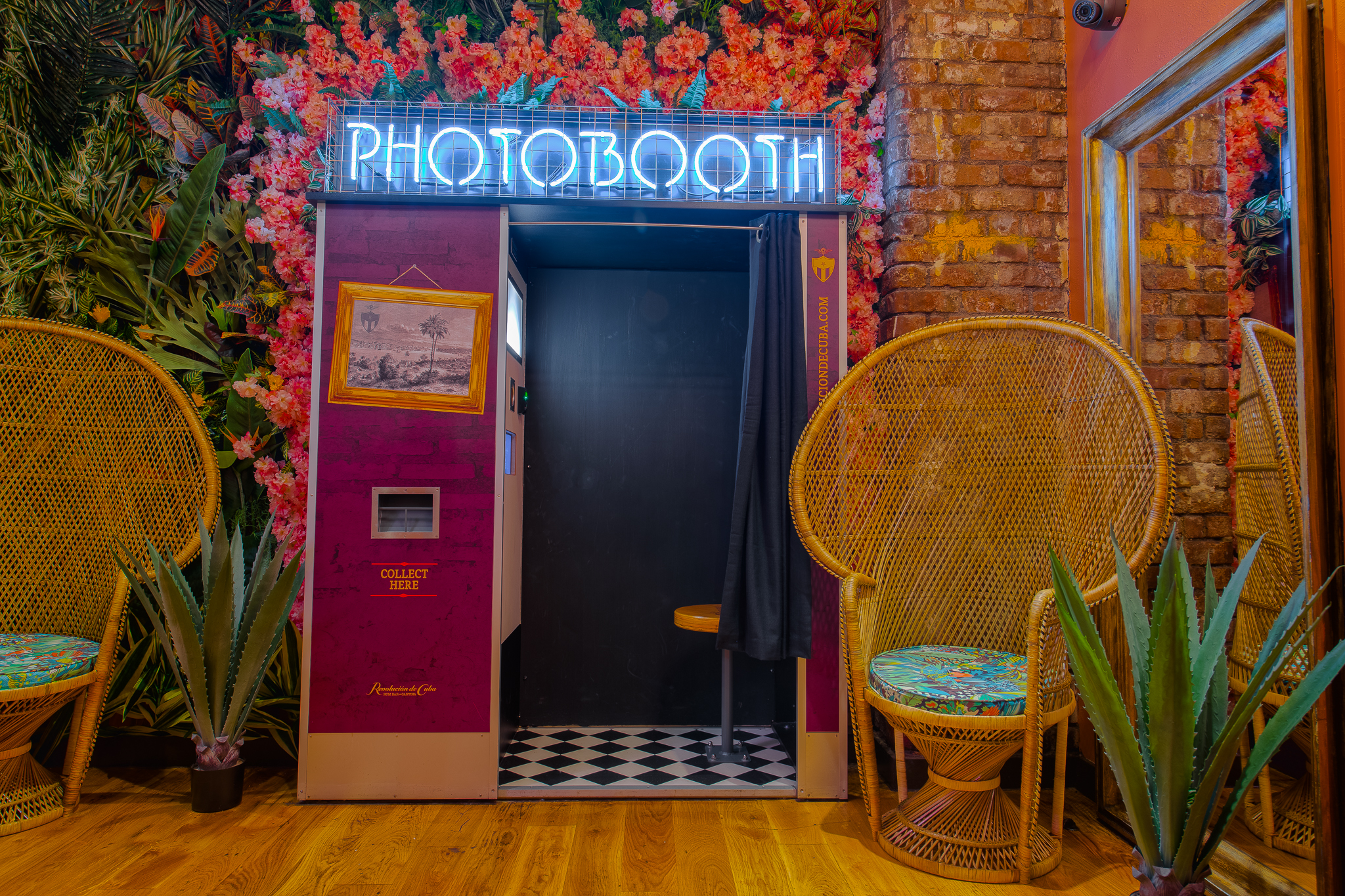 Vibrant photobooth with floral backdrop in Havana Rooms, perfect for events and engagement.