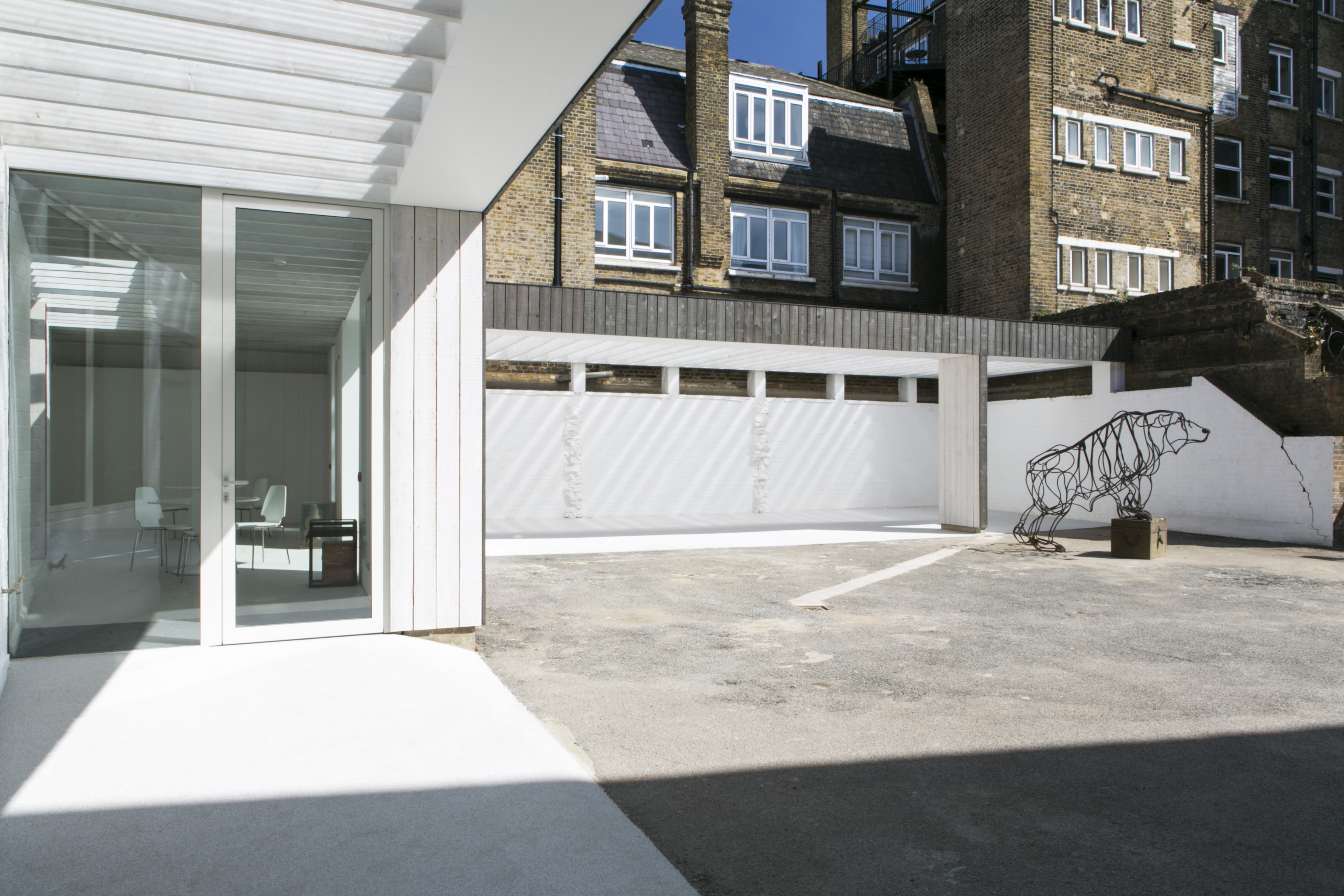 Modern outdoor event space at Bow Arts with unique sculpture and natural light.