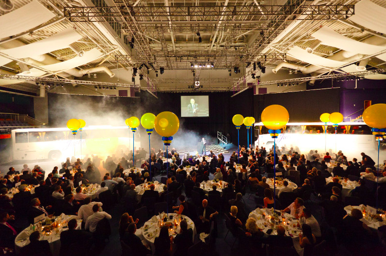 "Centaur Cheltenham Racecourse event with elegant tables, speaker, balloons, networking"