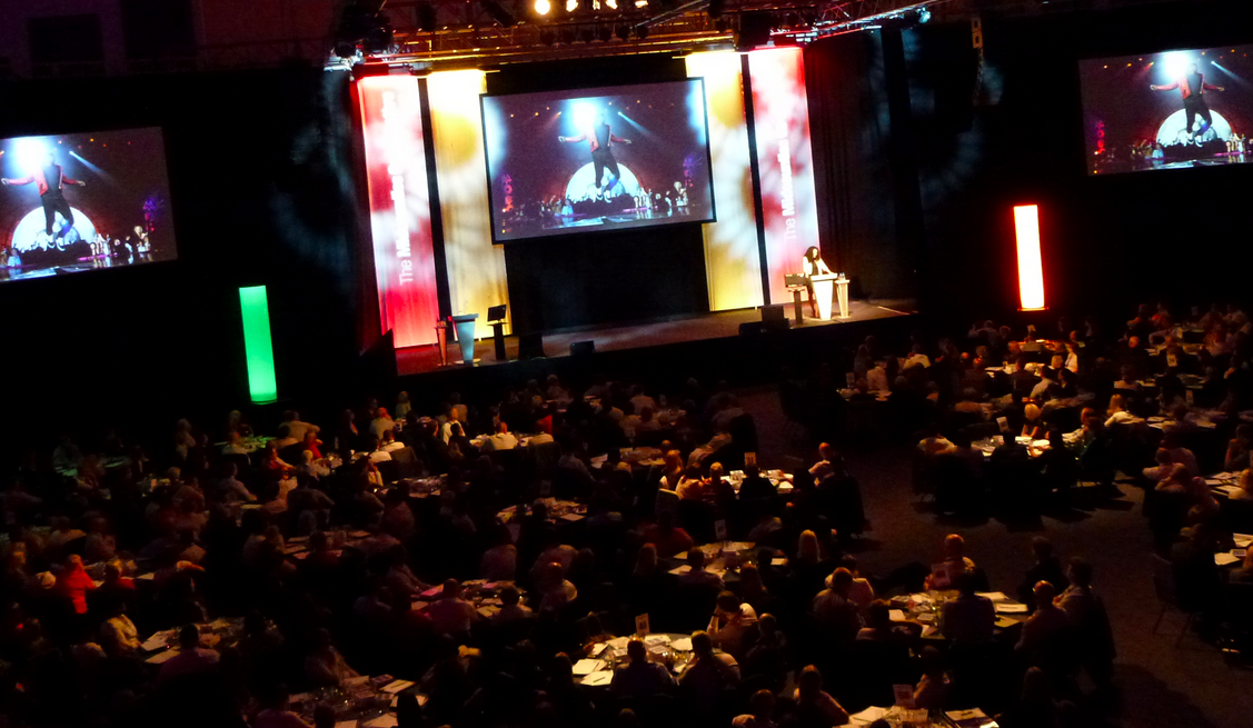 Centaur event at Cheltenham Racecourse with vibrant stage and engaged audience.