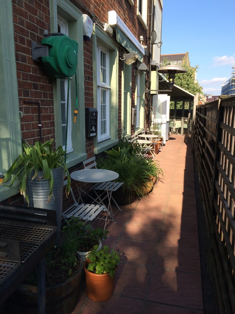 Charming outdoor seating at The Terrace Bar & Garden for casual networking events.