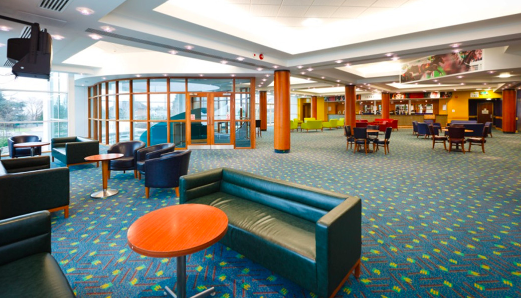 Modern Cheltenham Racecourse venue with vibrant colors for networking events.