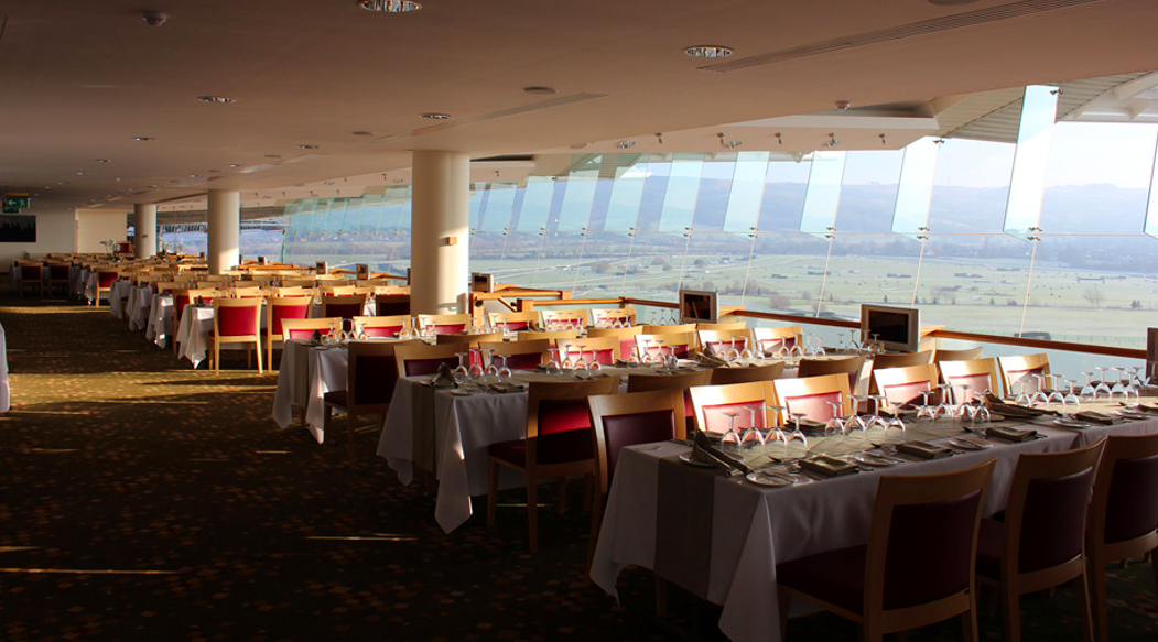 Panoramic dining area at Cheltenham Racecourse, ideal for corporate events and gatherings.