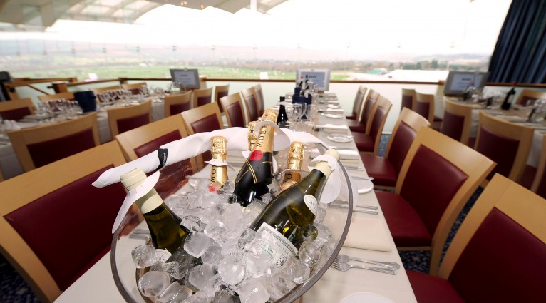 Elegant table setting with champagne at Cheltenham Racecourse for upscale events.
