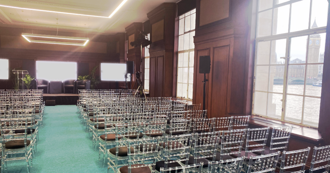 Modern Riverside event space with stage & screens