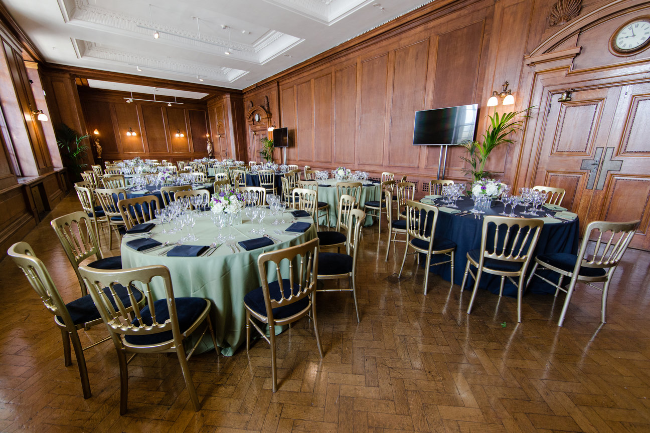 Elegant event space with round tables, perfect for corporate gatherings and formal events.