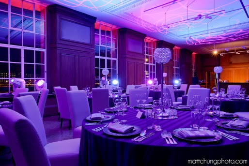 Elegant Riverside Rooms dinner setup with purple linens for corporate events and weddings.