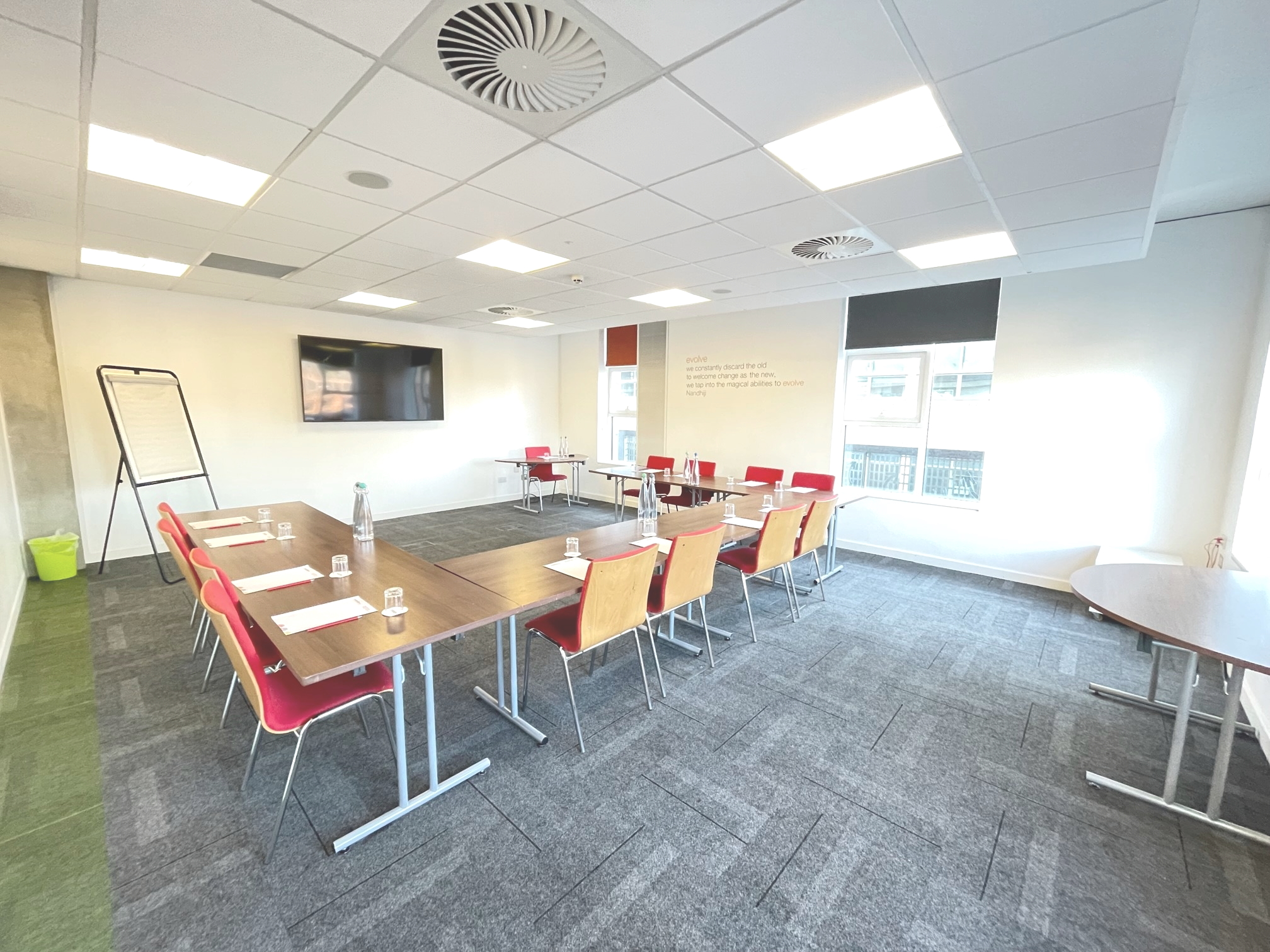 Evolve meeting room in Manchester with U-shaped table for collaborative workshops.