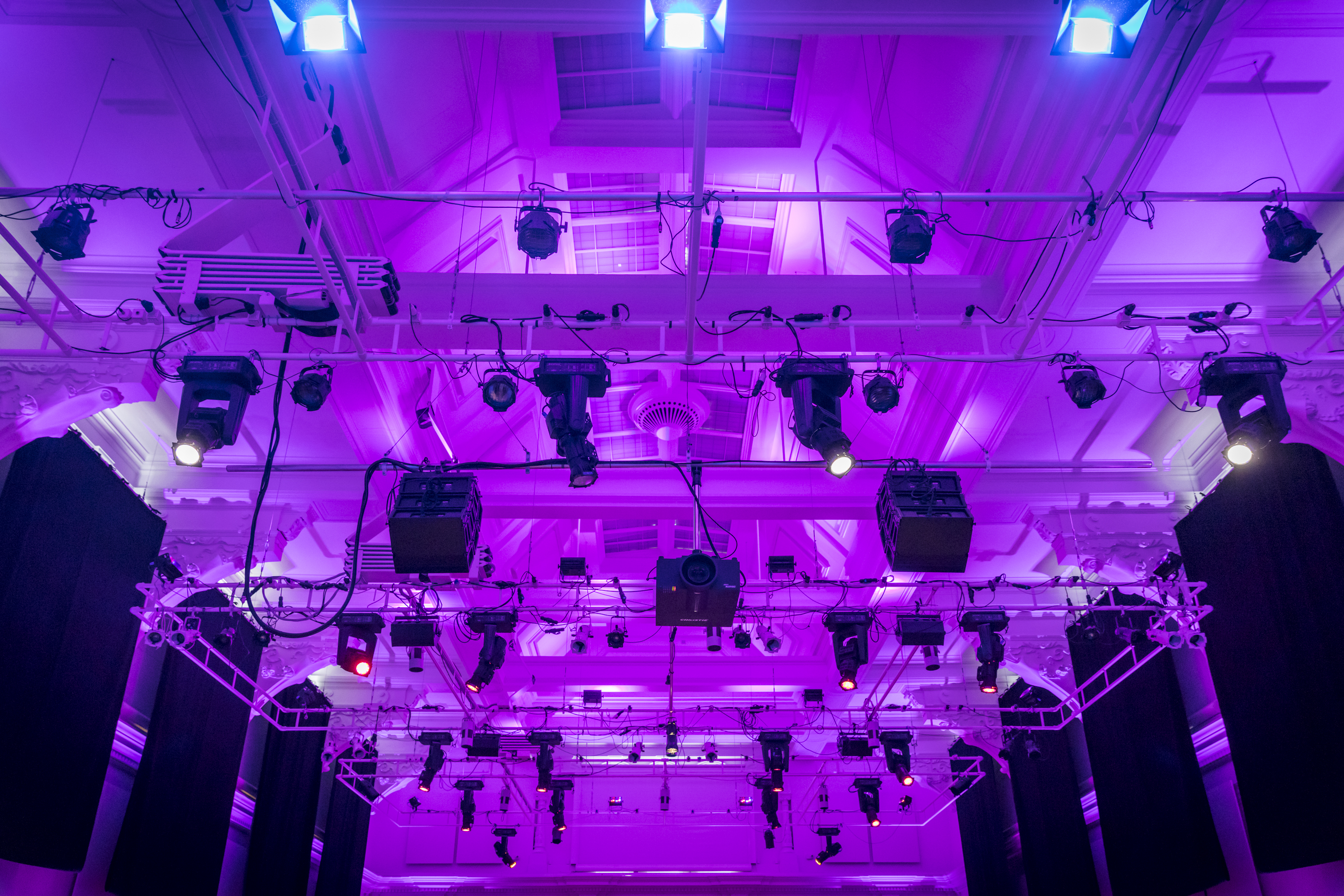 Great Hall at Bishopsgate Institute, vibrant purple lighting for corporate events and performances.