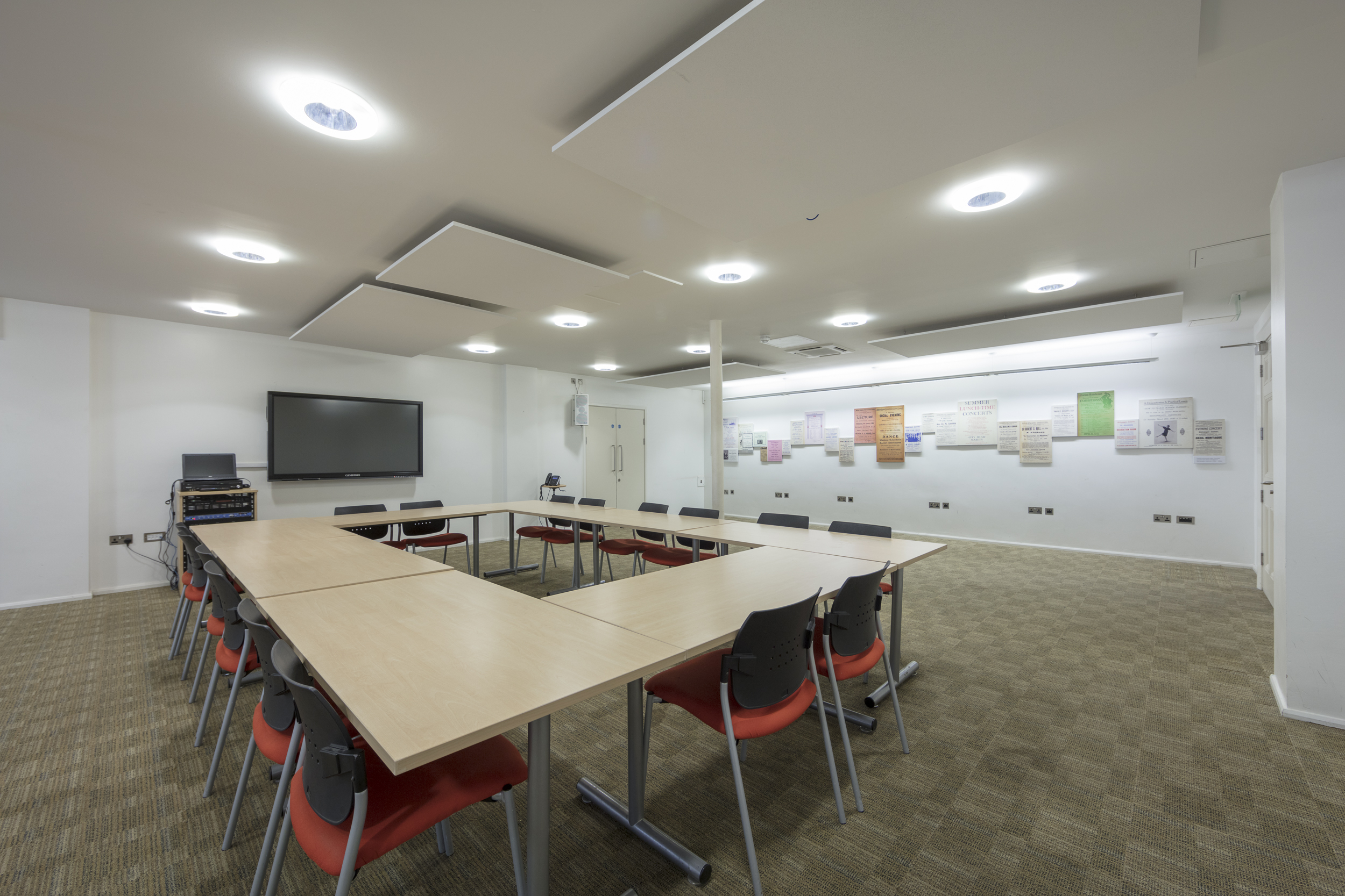 Versatile meeting room with large table at Bishopsgate Institute for workshops and presentations.