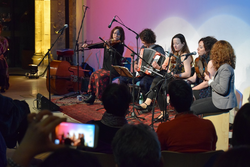 Lively ensemble performance in warm-lit Nave, ideal for cultural events and intimate gatherings.