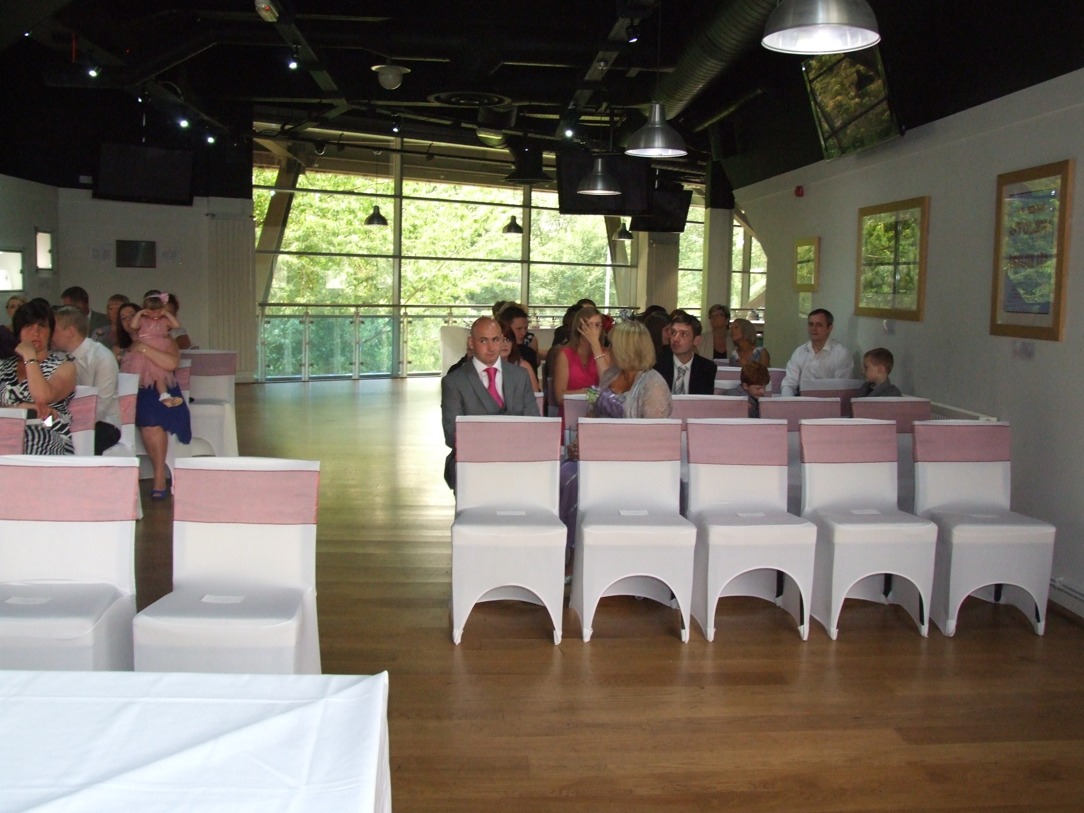Event space at McGregors, Villa Park, with white chairs and pink sashes for a ceremony.