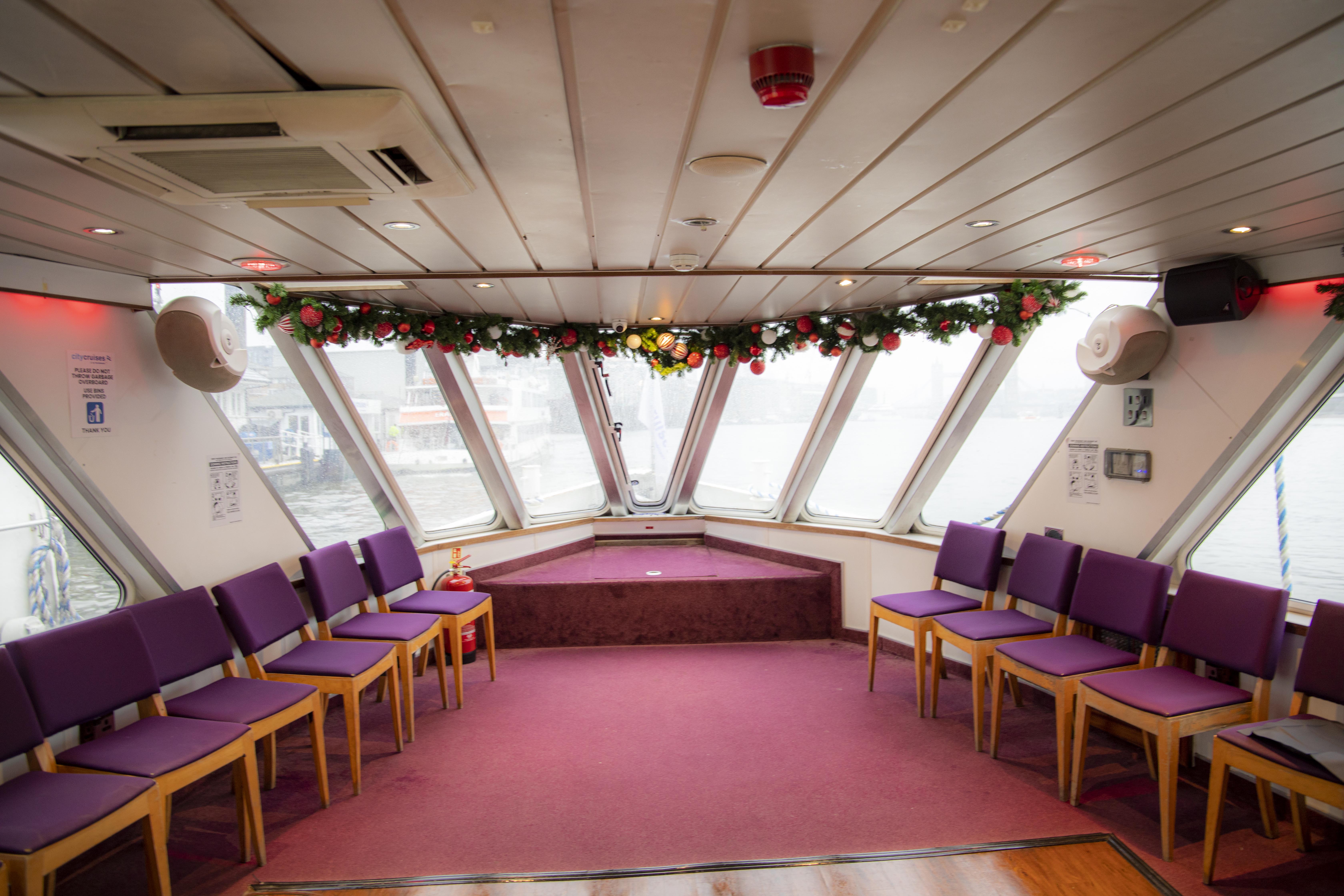 MV Mayflower Garden: elegant boat event space with purple chairs for workshops and meetings.