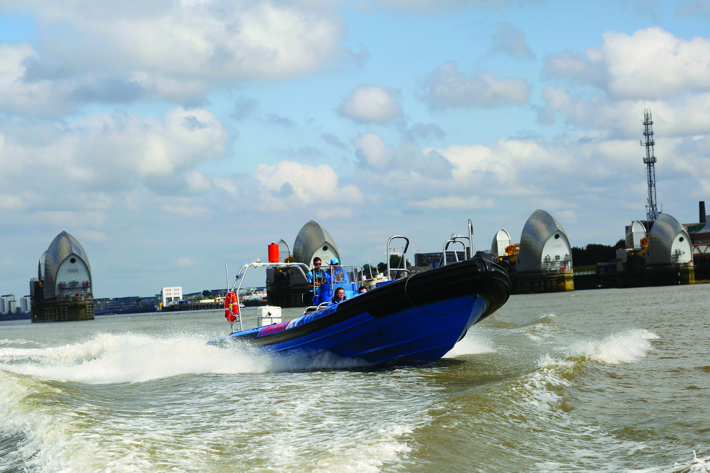 Thamesjet boat navigating water with iconic landmarks, ideal for corporate events and team-building.