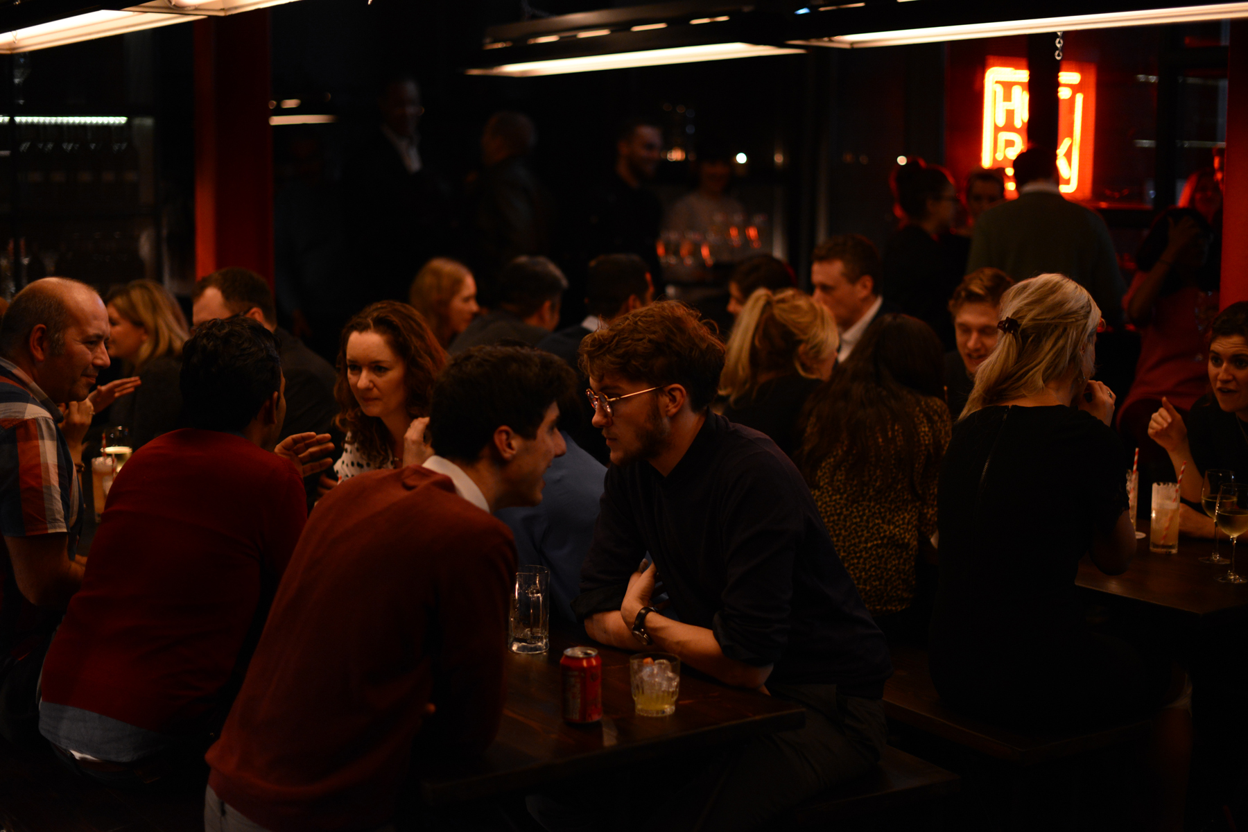 Vibrant networking event at HotBox London with engaged attendees and warm lighting.
