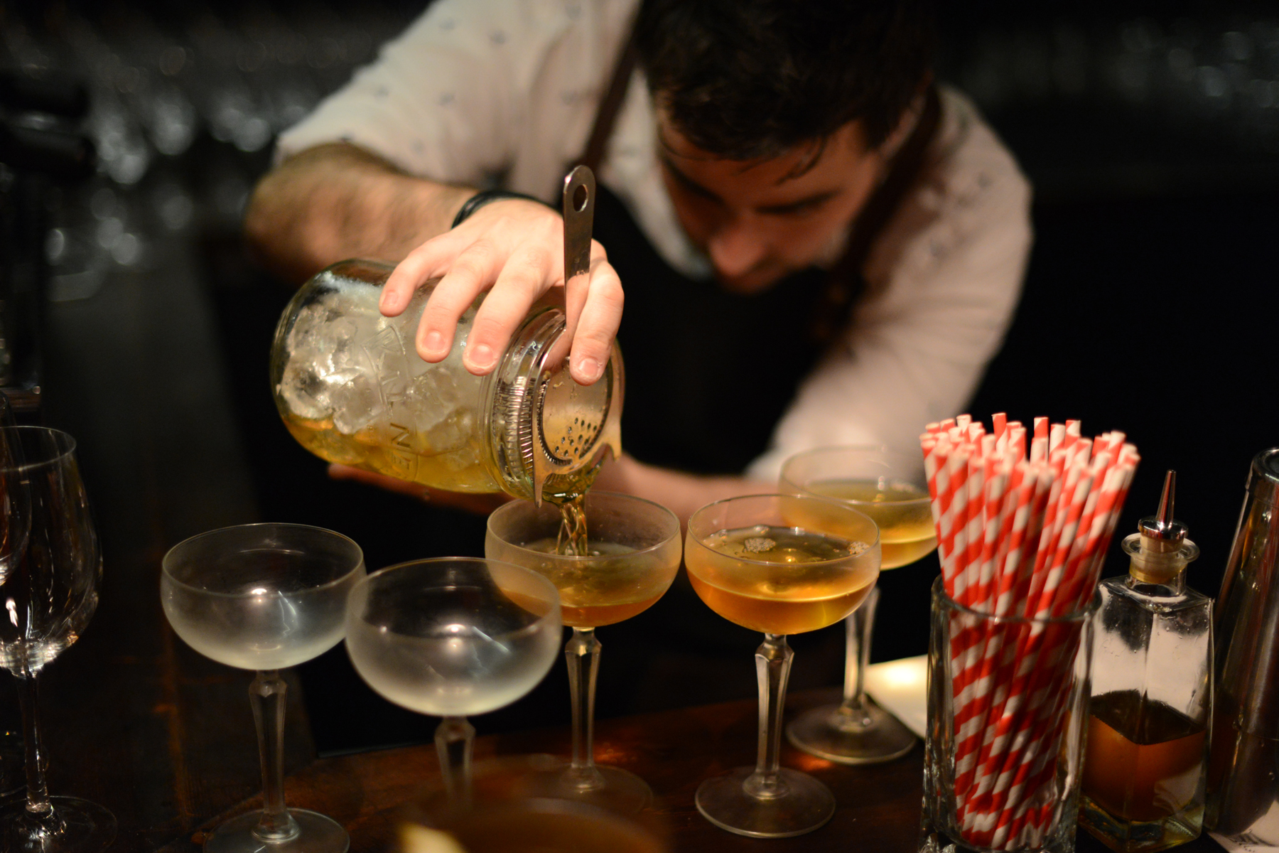 Bartender pouring cocktails in vintage glasses at HotBox Spitalfields, London event catering.