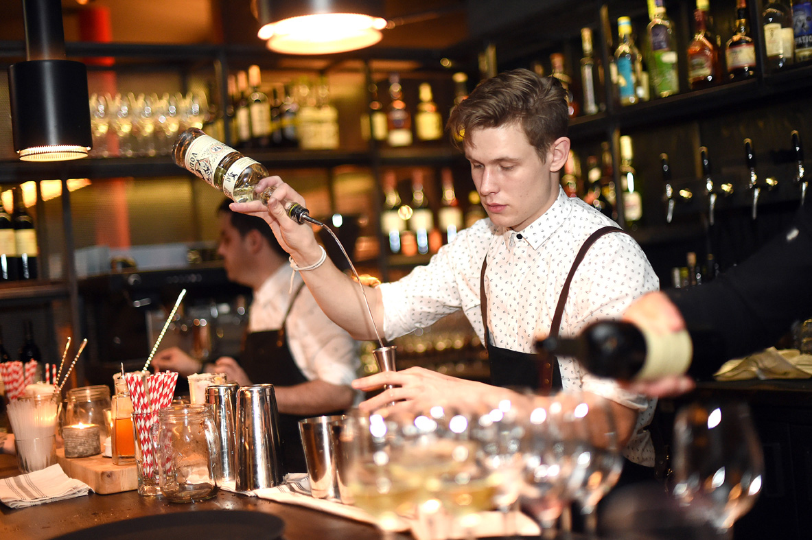 Bartender mixing drinks at HotBox Spitalfields, perfect for networking events.