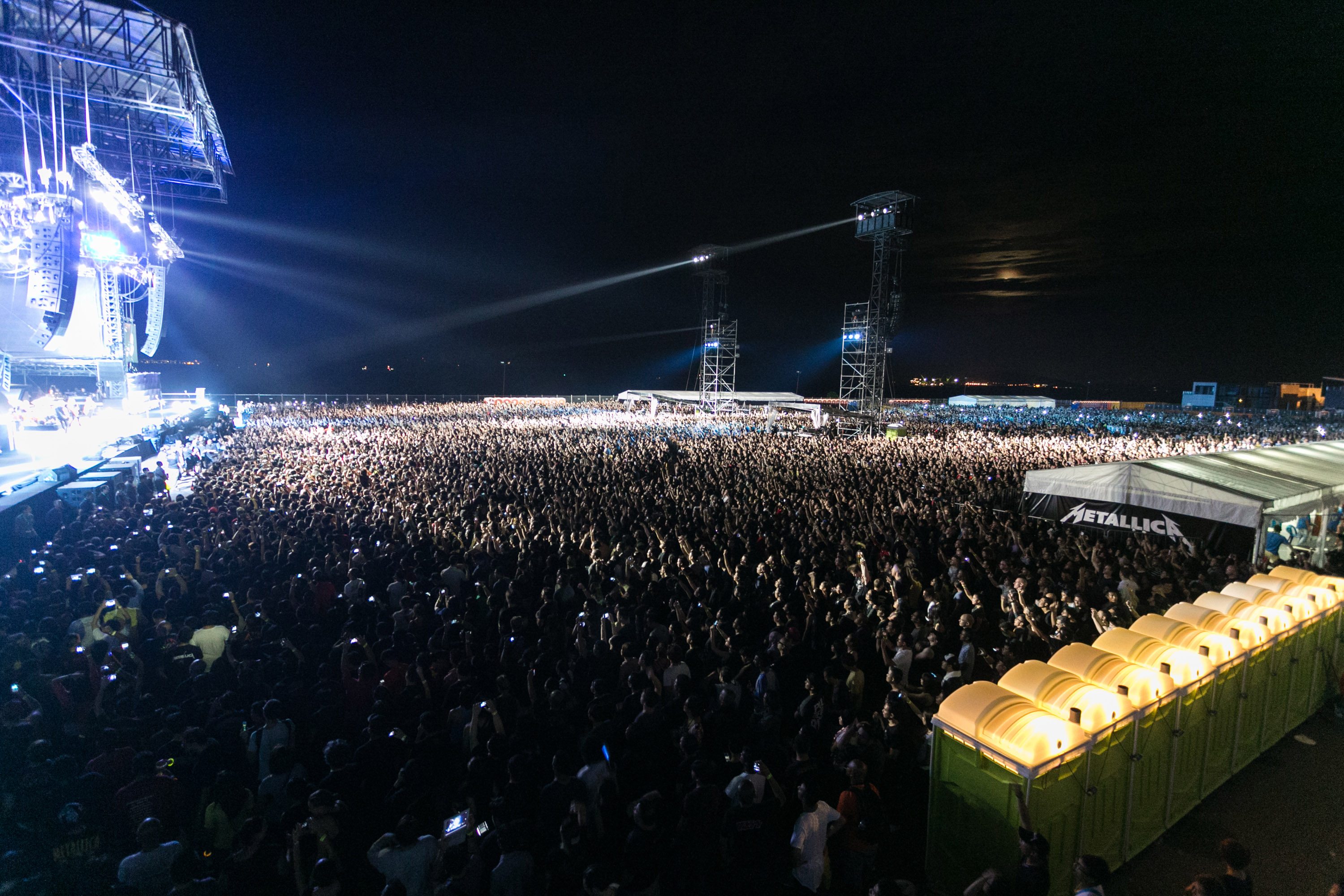 Outdoor concert at Changi Exhibition Centre with a large crowd and vibrant stage lights.