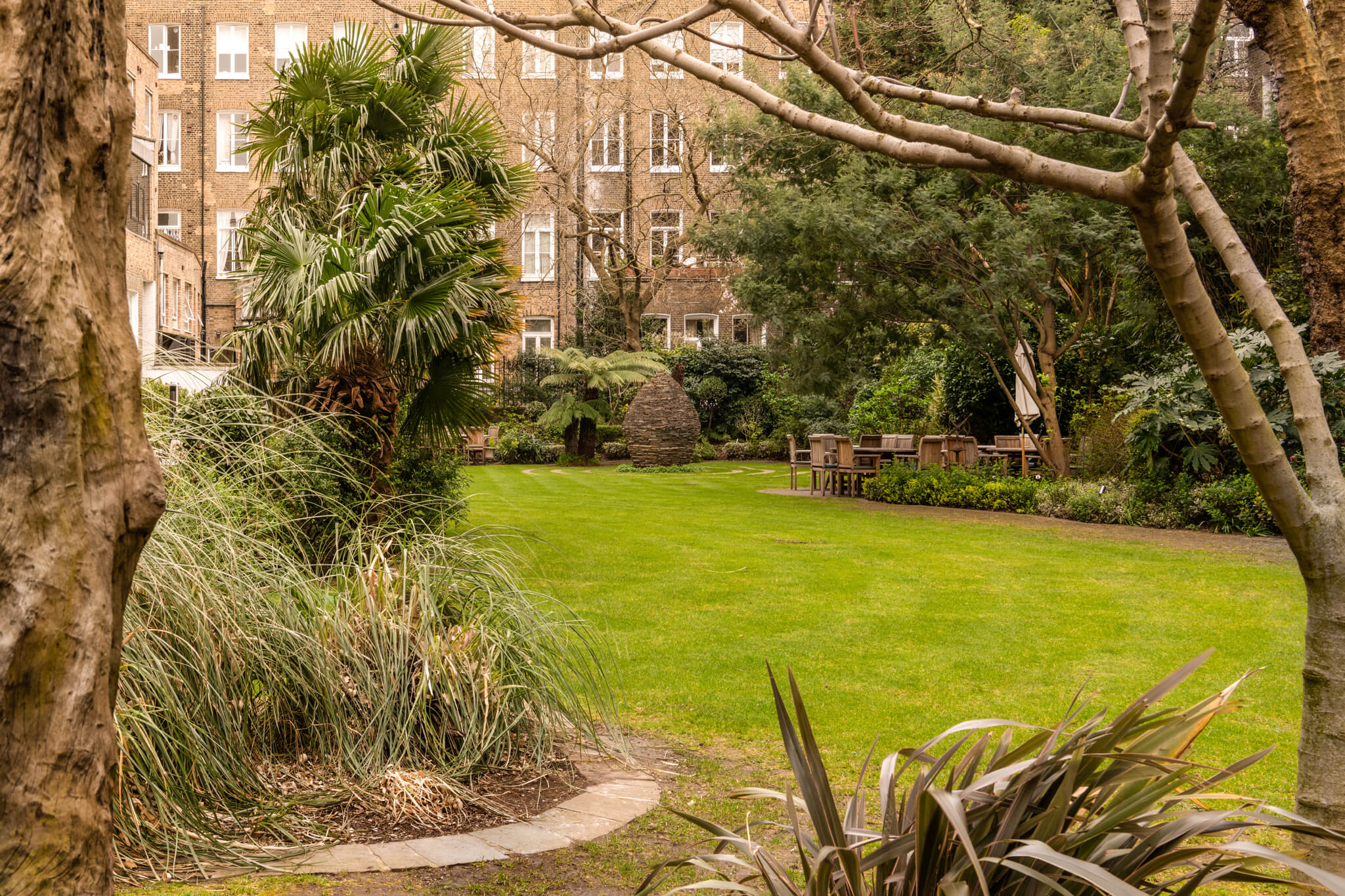 Serene garden at K+K Hotel George, perfect for networking events and conferences.