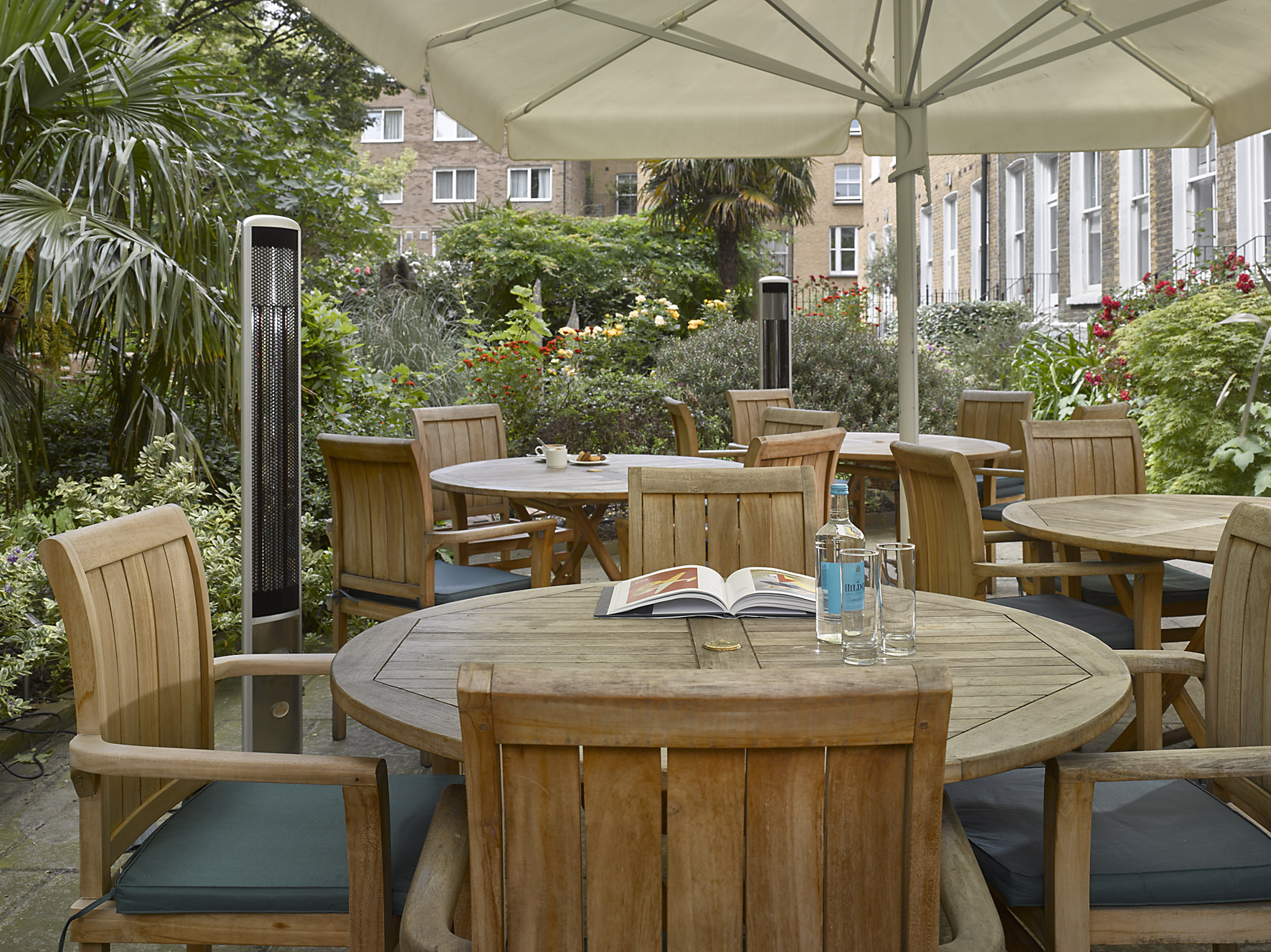 Tranquil garden meeting space at K+K Hotel George, ideal for networking events.