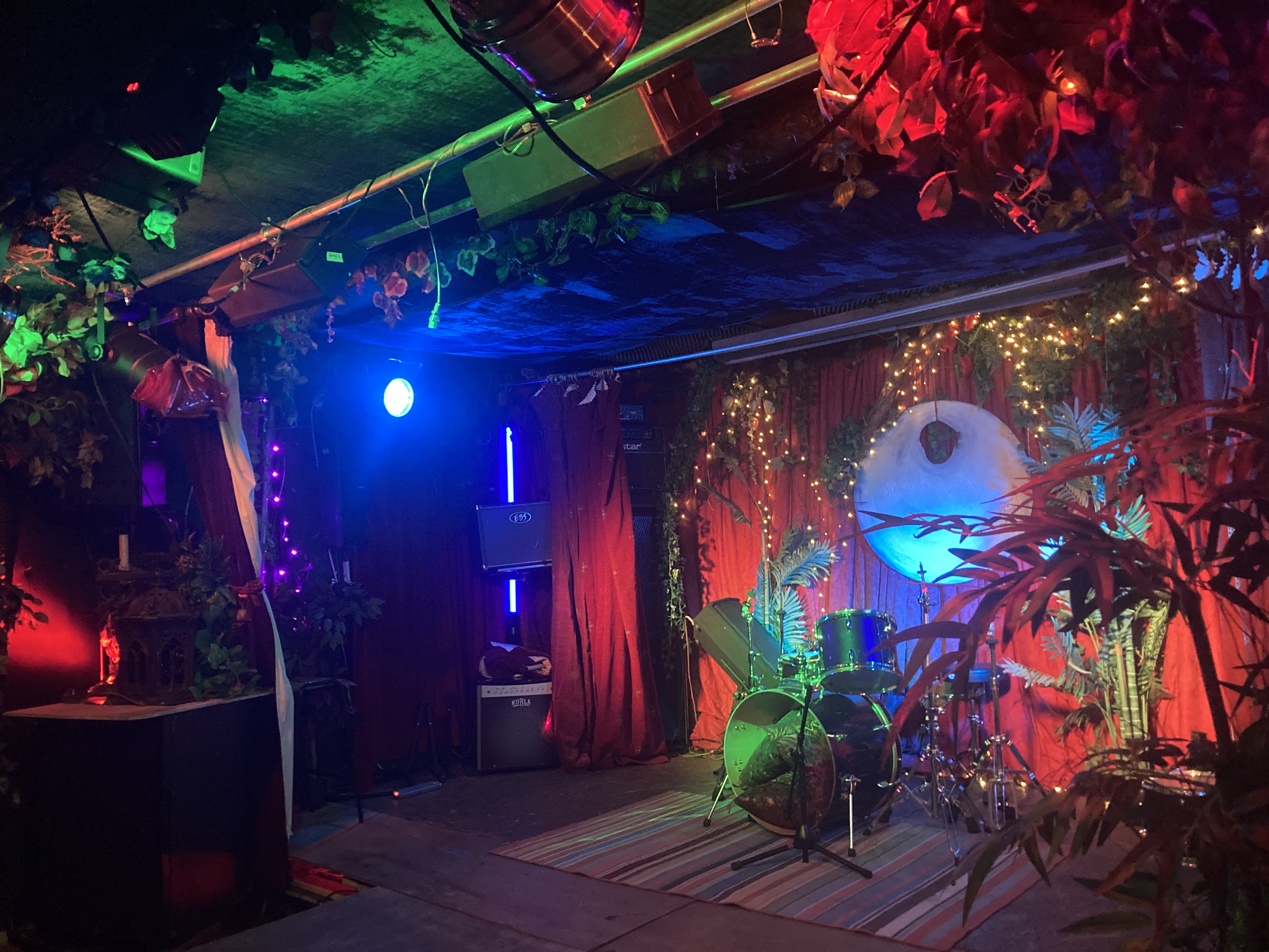 Vibrant event space with stage, ideal for intimate gatherings and live performances.