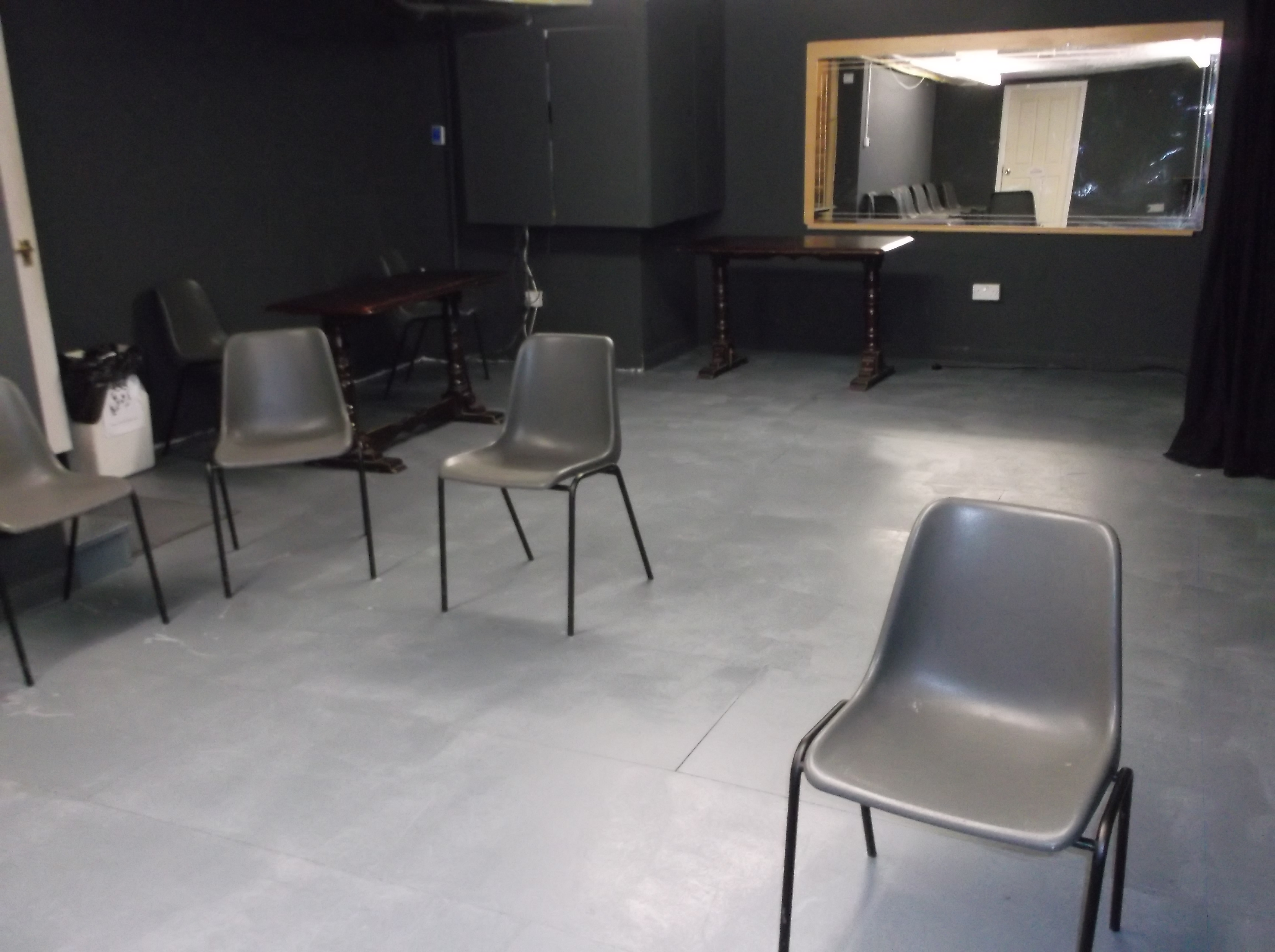 Minimalist meeting space in The Basement, Calder Theatre Bookshop for workshops and gatherings.
