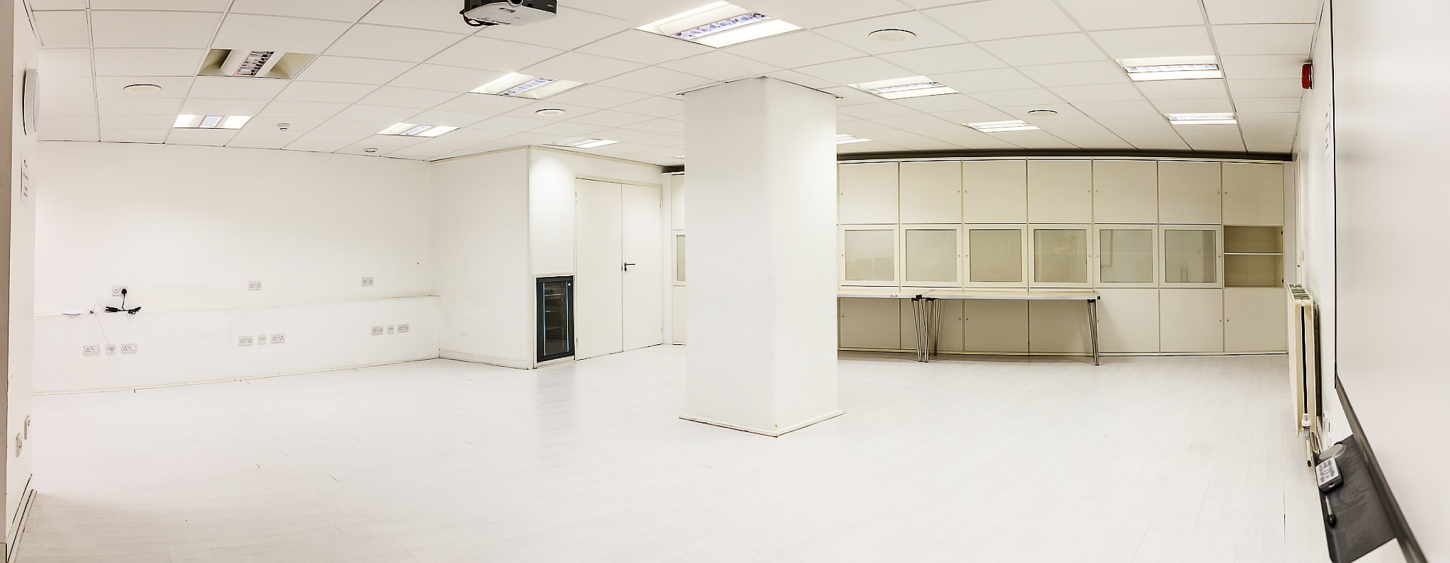 Well-lit, blank meeting space at Eastside Educational Trust for flexible events.