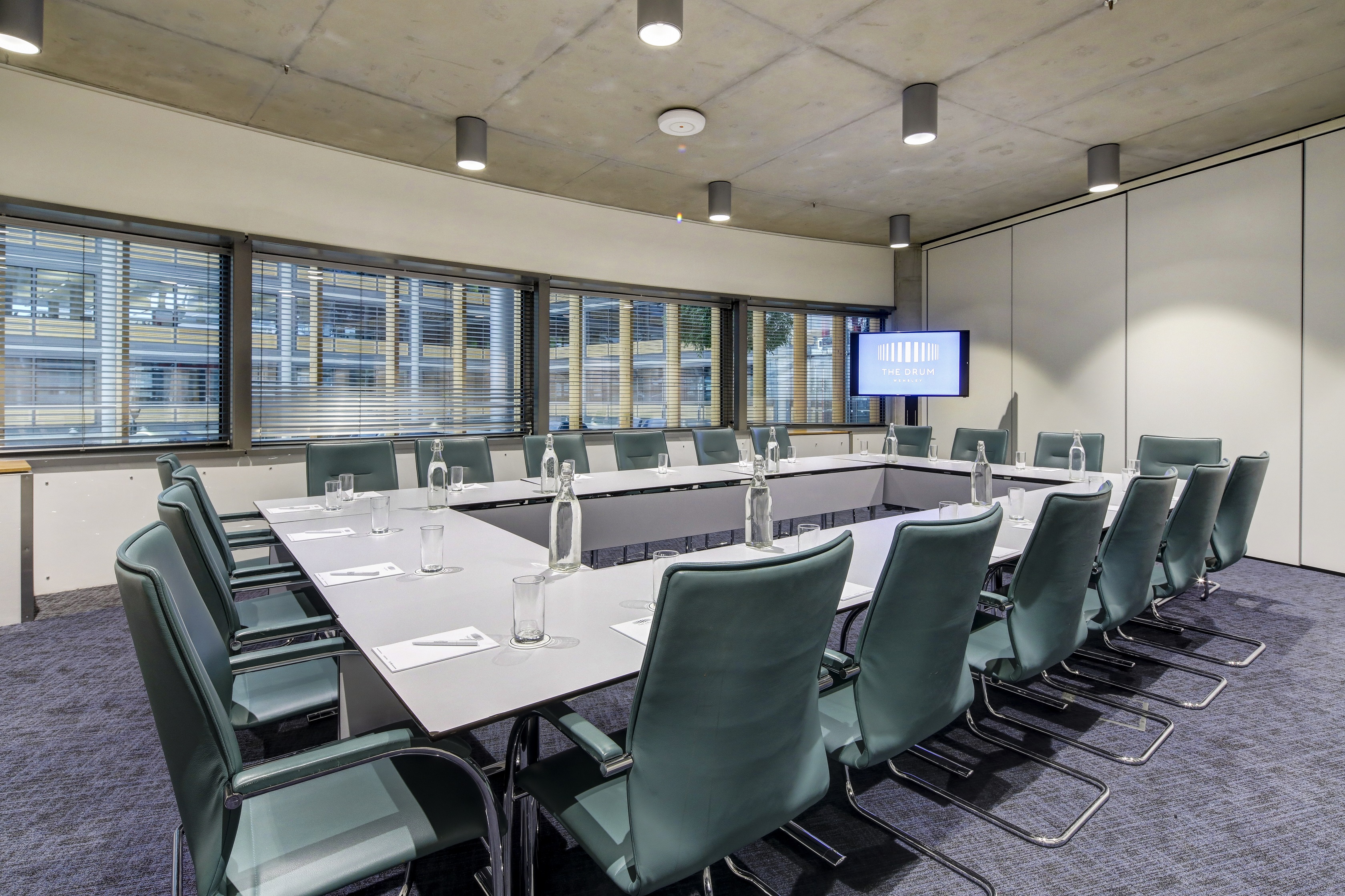 Modern boardroom at Wembley with large table, ideal for corporate meetings and workshops.
