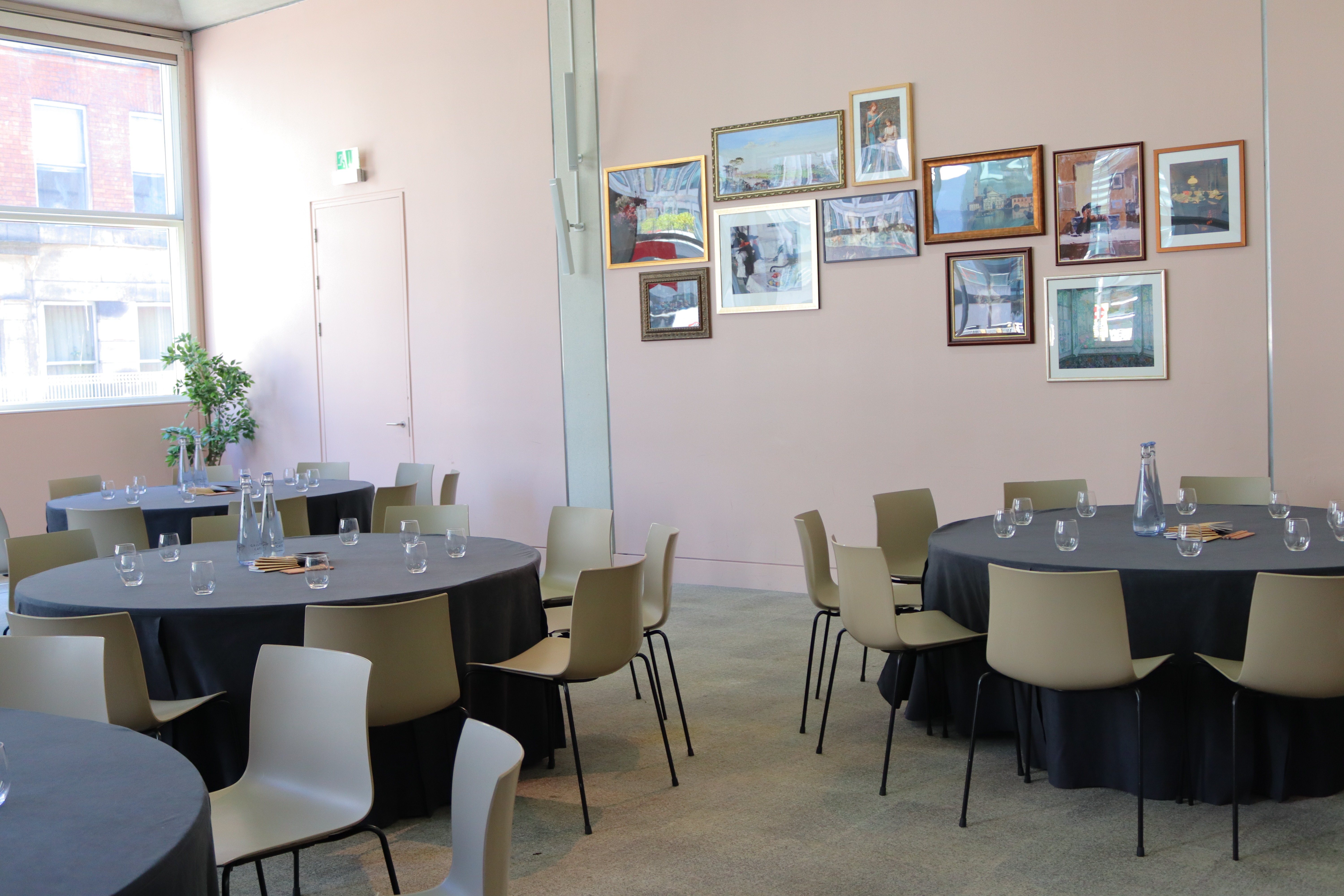 Lecture Room at Manchester Art Gallery, set for meetings with round tables and natural light.