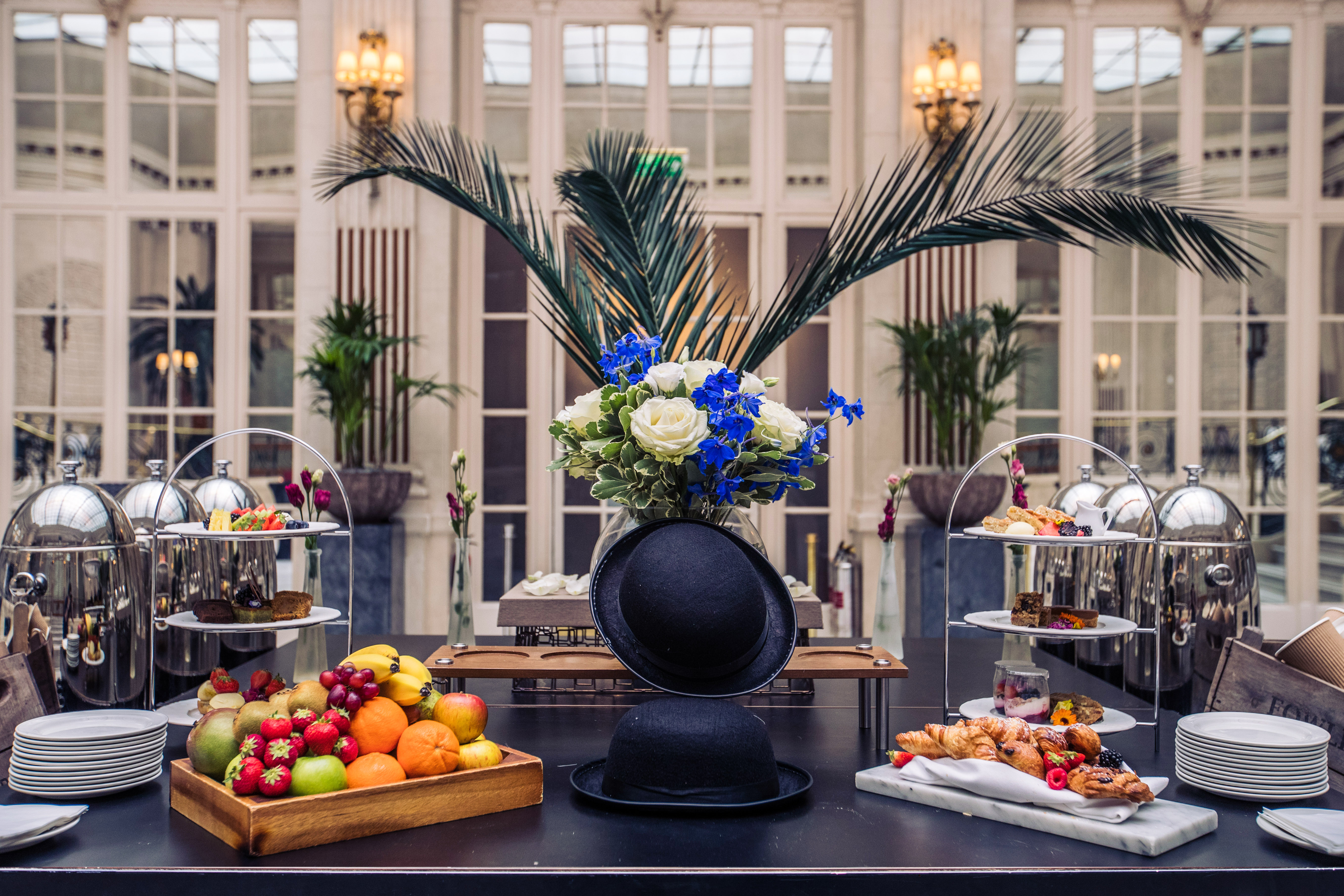 Elegant buffet setup with floral centerpiece at Palm Court, Waldorf Hilton, London event.