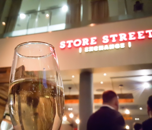 Store Street Exchange event venue with sparkling wine, ideal for networking and celebrations.