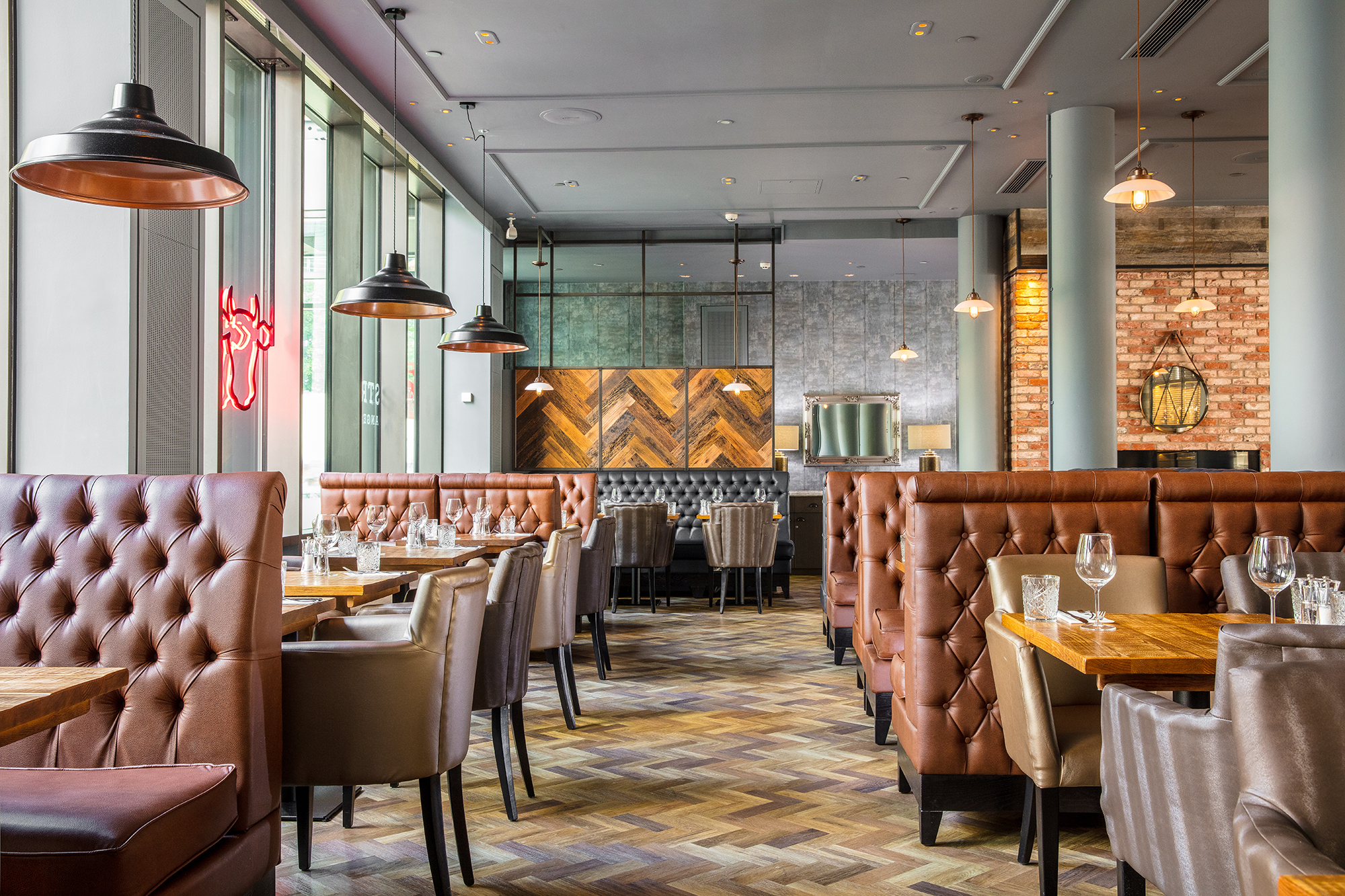 Modern restaurant at DoubleTree Manchester with plush seating, ideal for events.