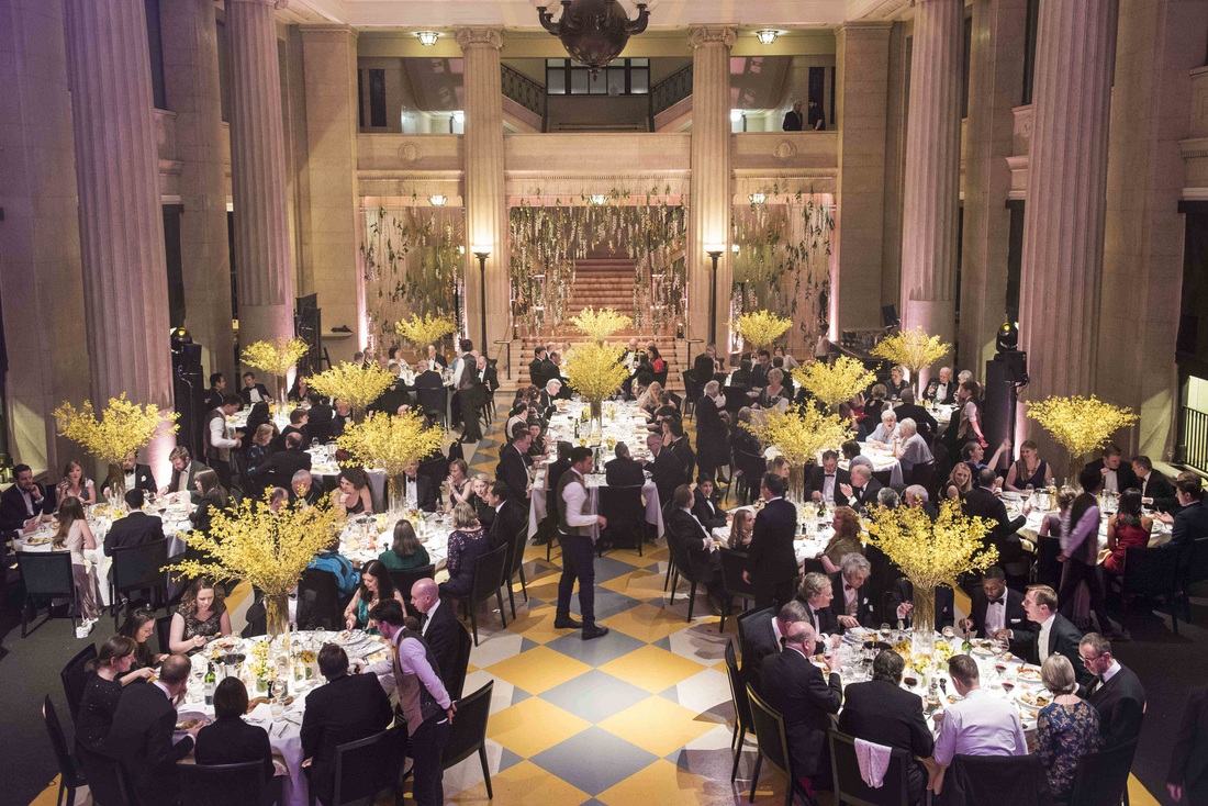 Elegant gala dinner in The Banking Hall with floral centerpieces and soft lighting.