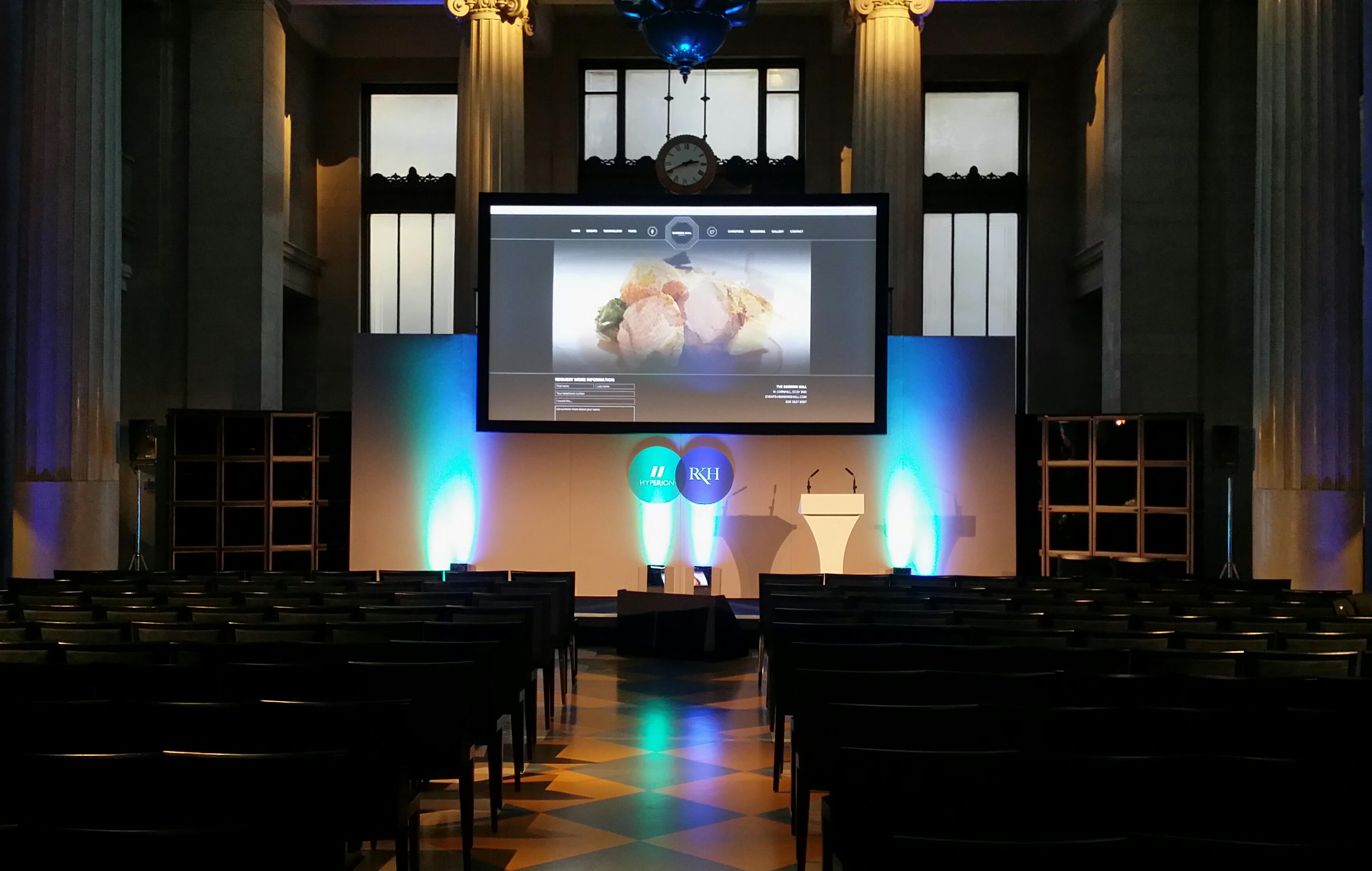 Main Hall with large screen, elegant architecture for corporate events and conferences.