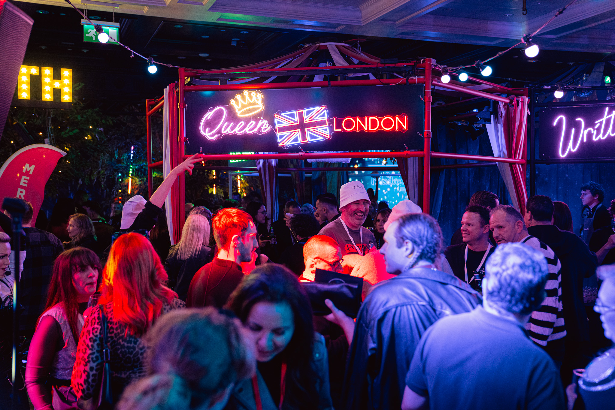 Vibrant event space at Madame Tussauds for LGBTQ+ gatherings with neon lights.