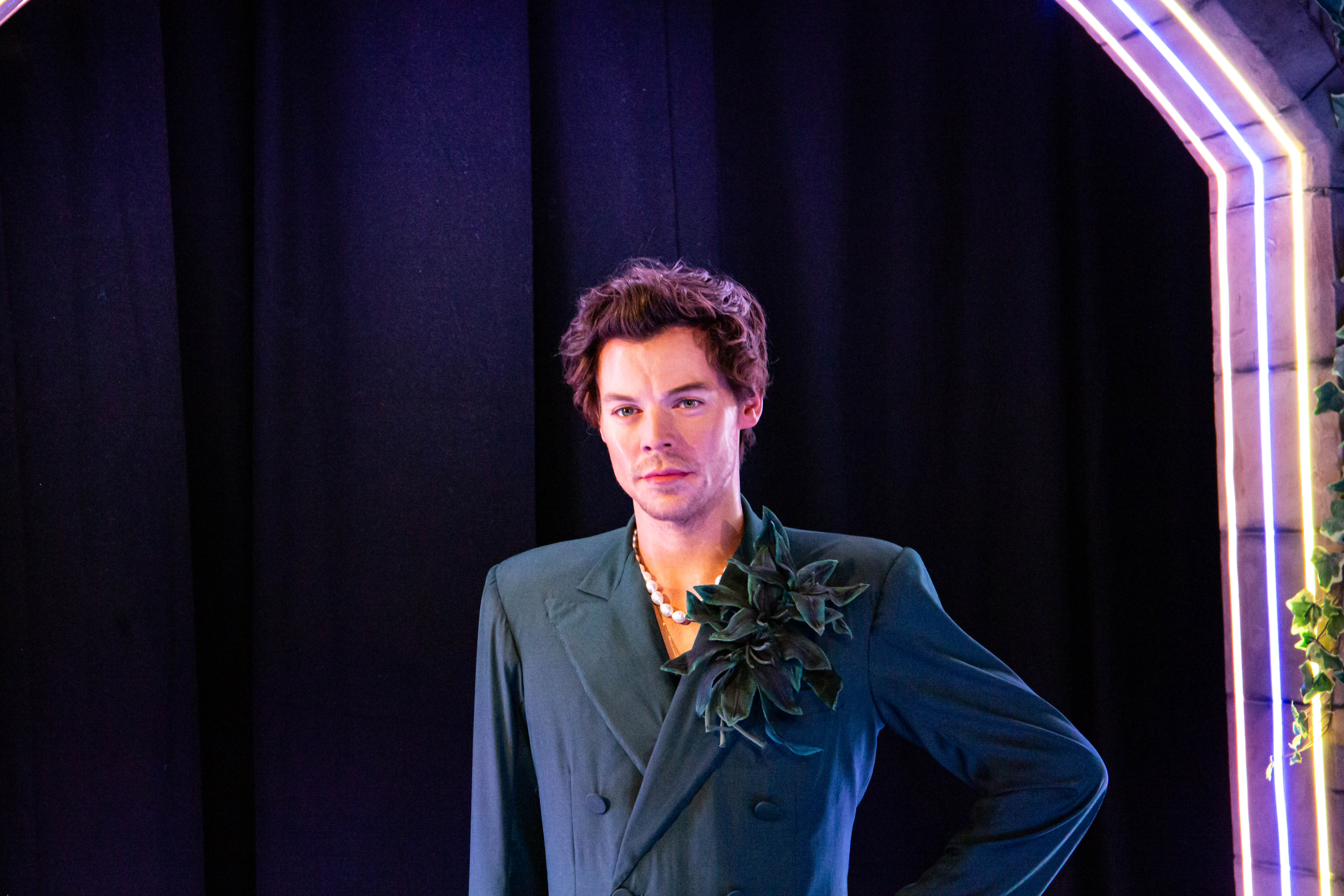 Stylish individual in striking outfit at Madame Tussauds World Stage event.