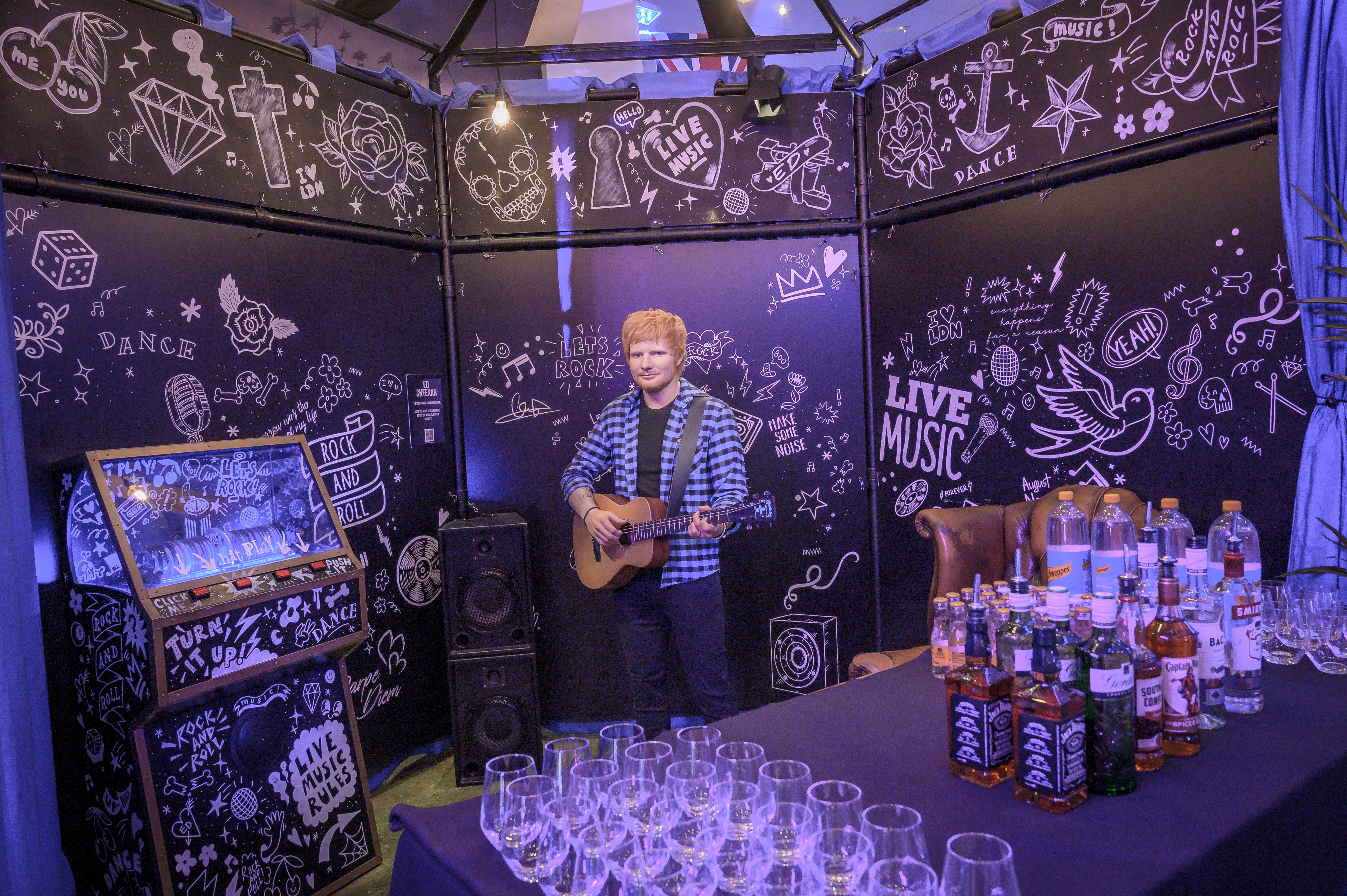 Life-sized musician figure at Madame Tussauds' vibrant event space for entertainment events.