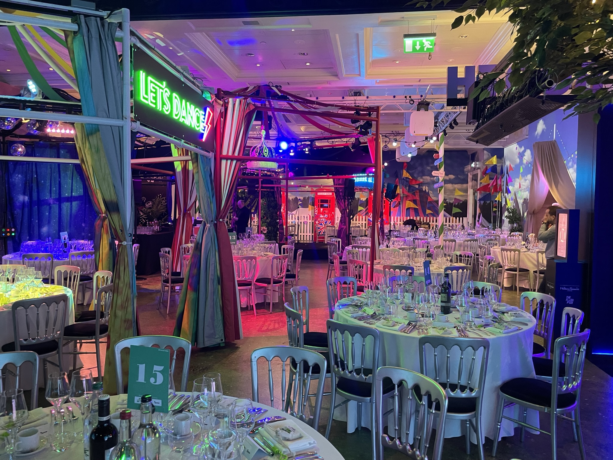 World Stage at Madame Tussauds, vibrant dinner setup with colorful lighting for events.