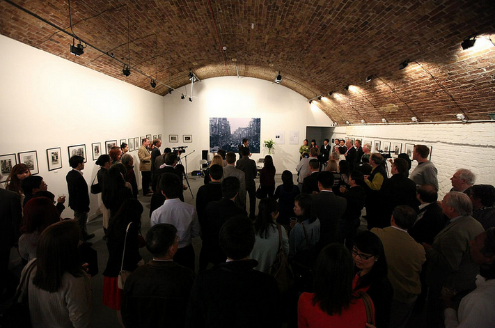 Networking event in Hoxton Arches with arched brick ceiling and art displays.
