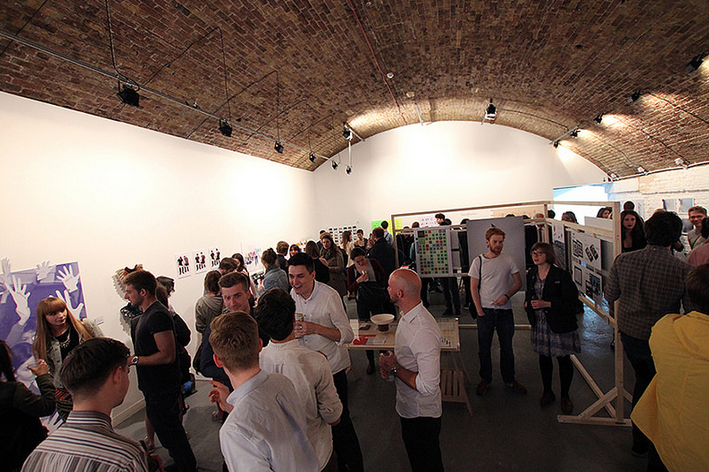 Vibrant networking event at Hoxton Arches with art displays and engaging attendees.
